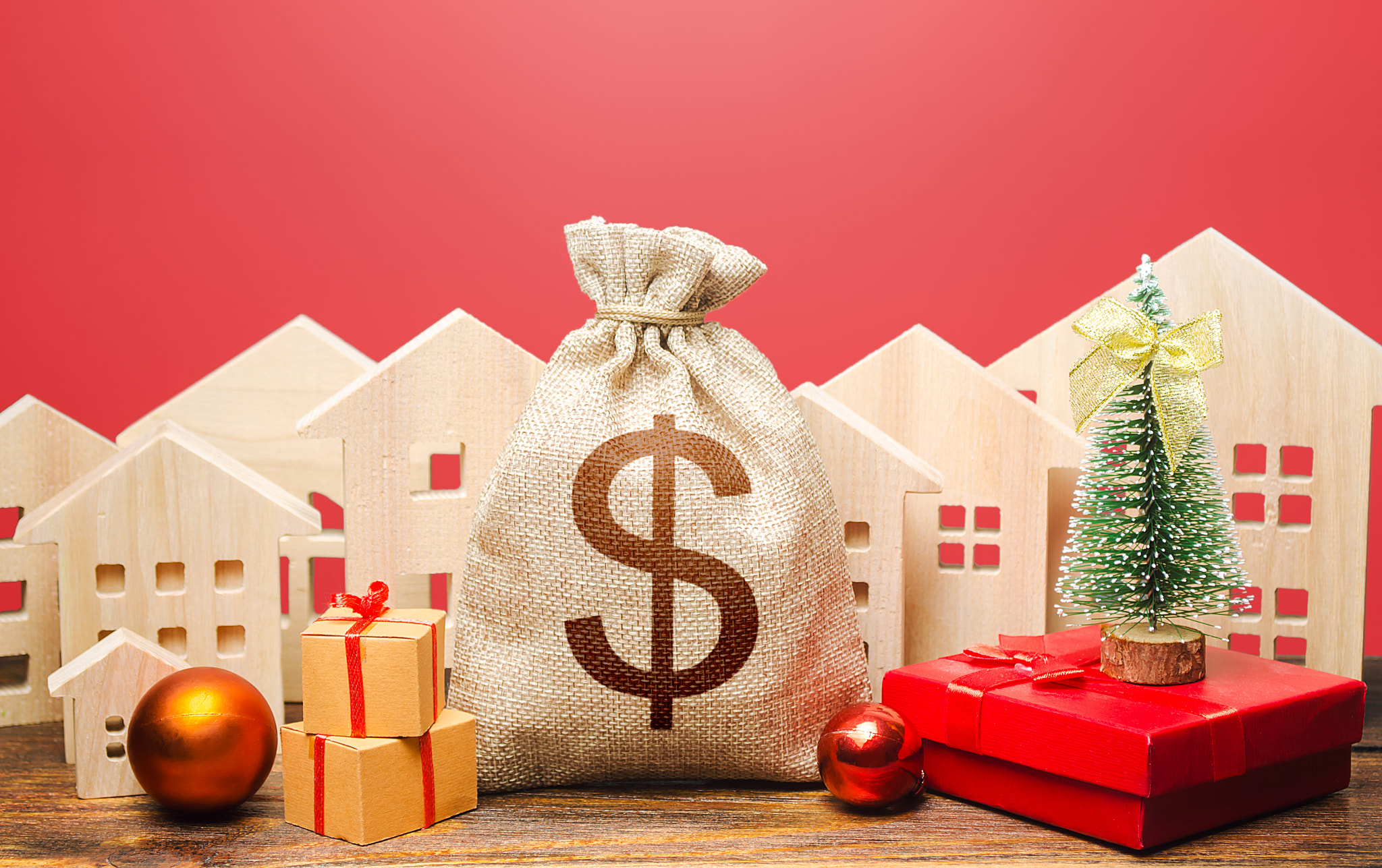 Dollar money bag and houses in a New Year's setting. Increase in investment attractiveness, prosperi