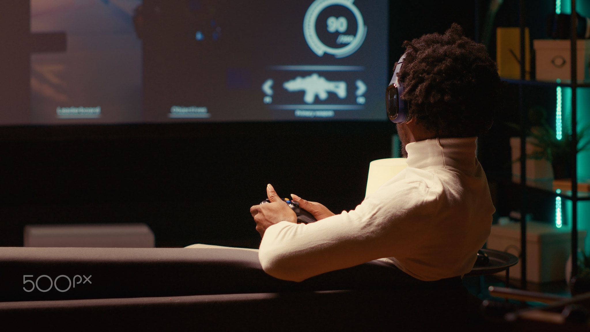 Man plays first person shooter videogame on smart TV with gun shooting