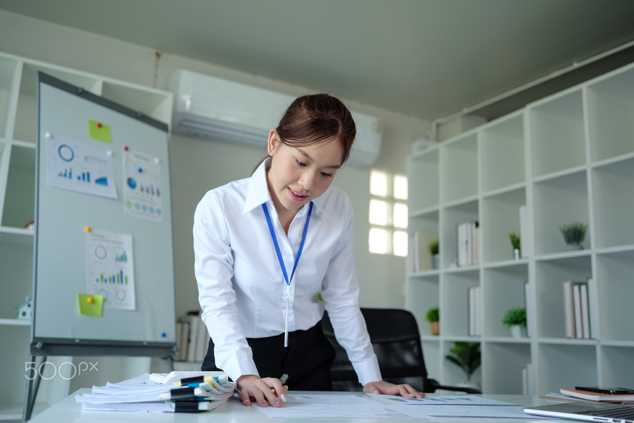 Portrait of beautiful asian young Business woman working audit and calculating expense annual