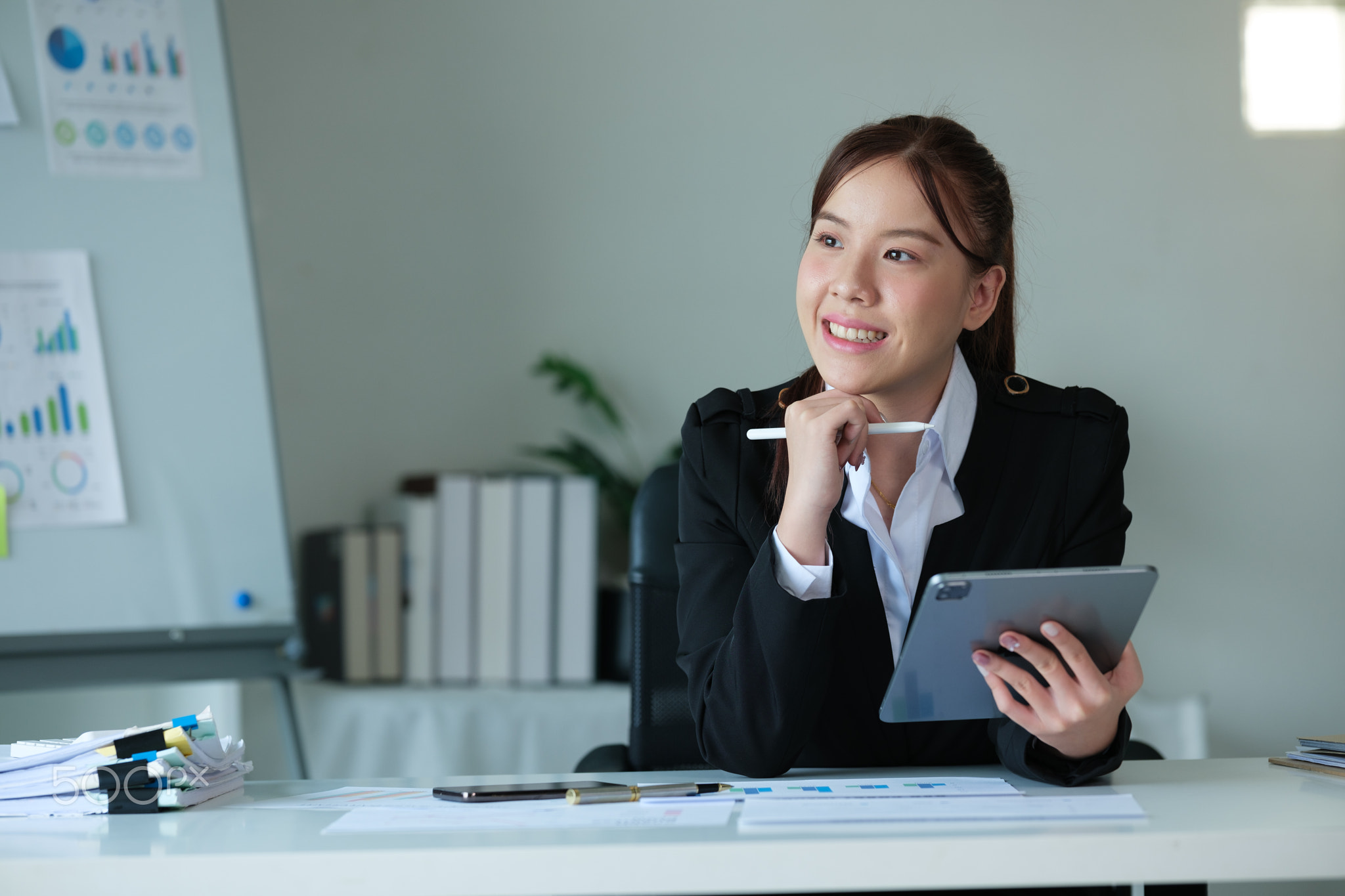Portrait of beautiful asian young Business woman working audit and calculating expense annual