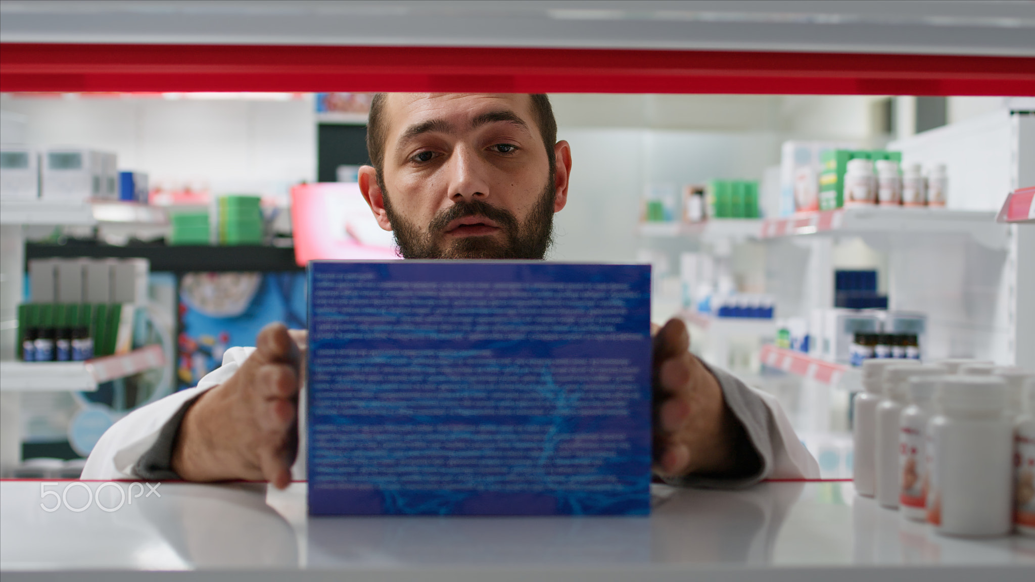 POV of retail worker arranging pharmacy products on shelves