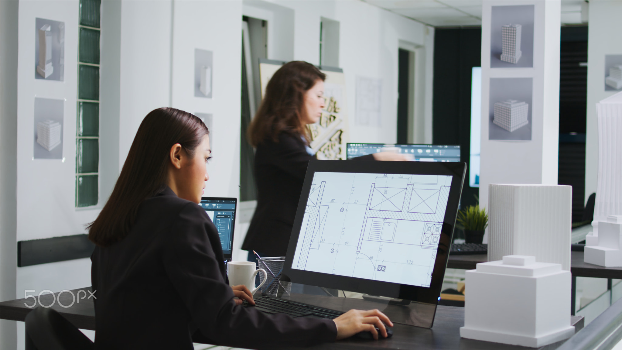 Asian graphic artist designing floor plan blueprint
