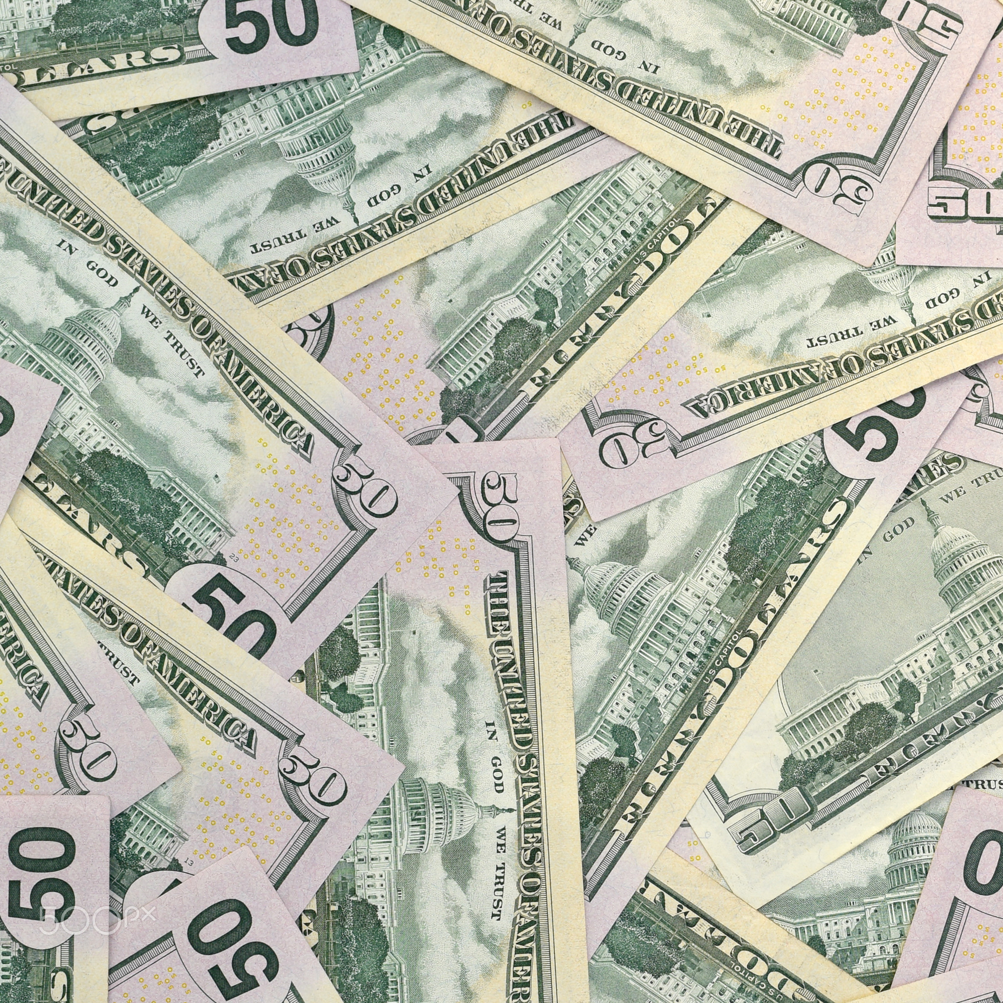 Many US fifty dollar bills on flat background surface close up. Flat lay top view. Abstract business
