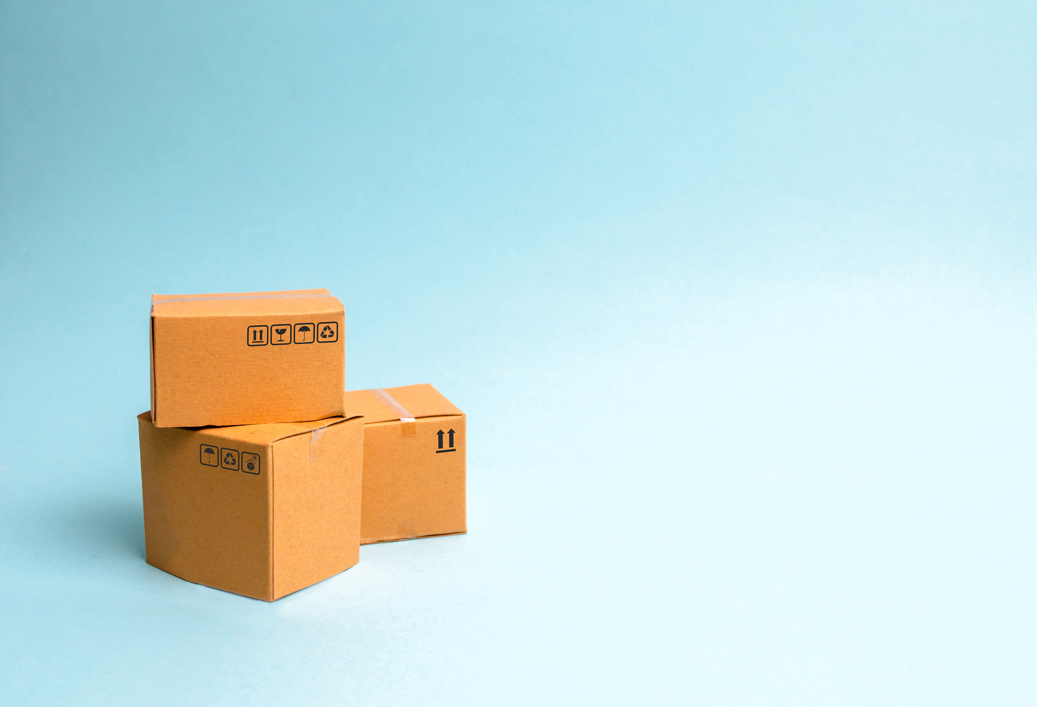 A bunch of boxes on a blue background. The concept of moving to a new home, delivery of goods or com