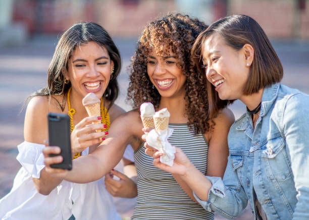 Beautiful women friends eating ice cream