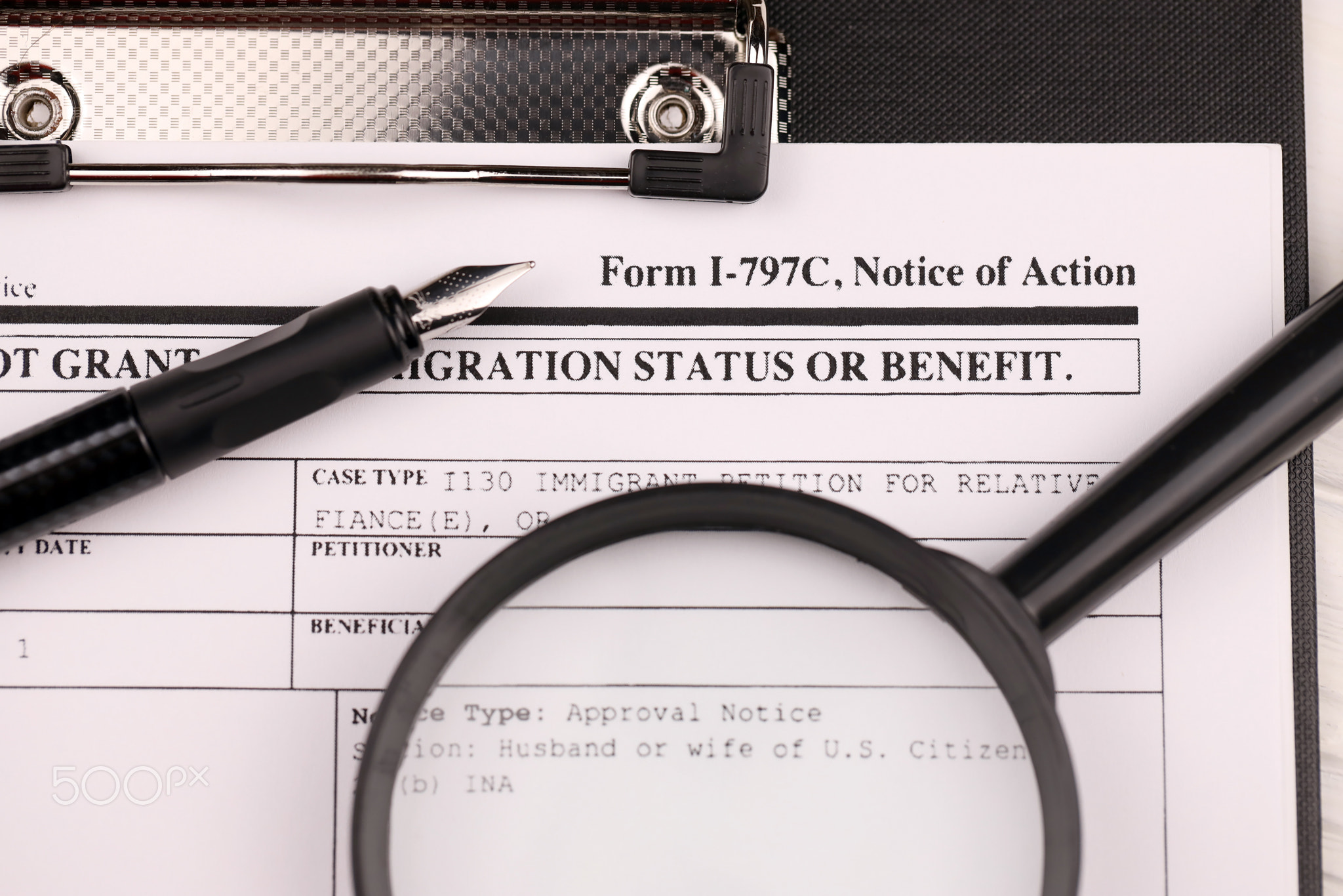 I-797c Notice of action blank form on A4 tablet lies on office table with pen and magnifying glass