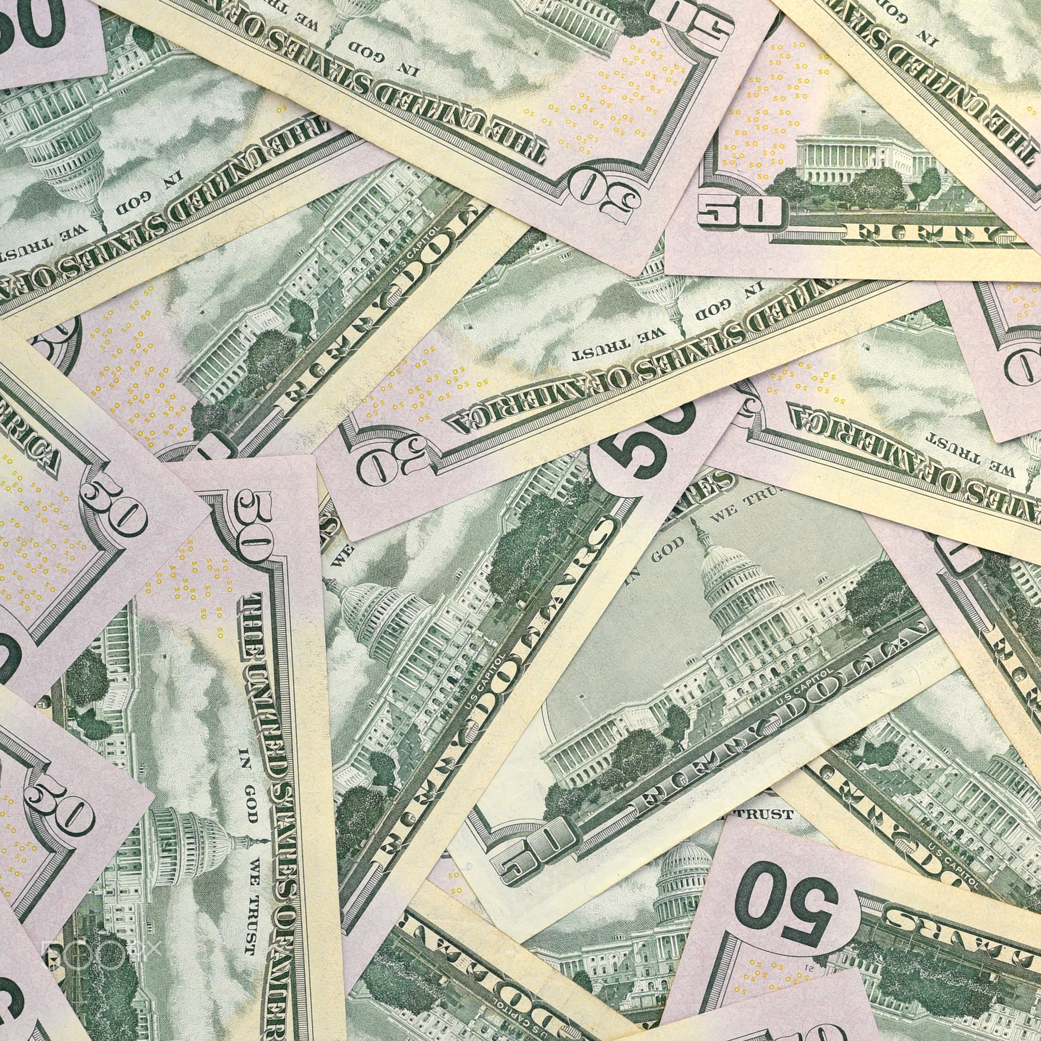 Many US fifty dollar bills on flat background surface close up. Flat lay top view. Abstract business