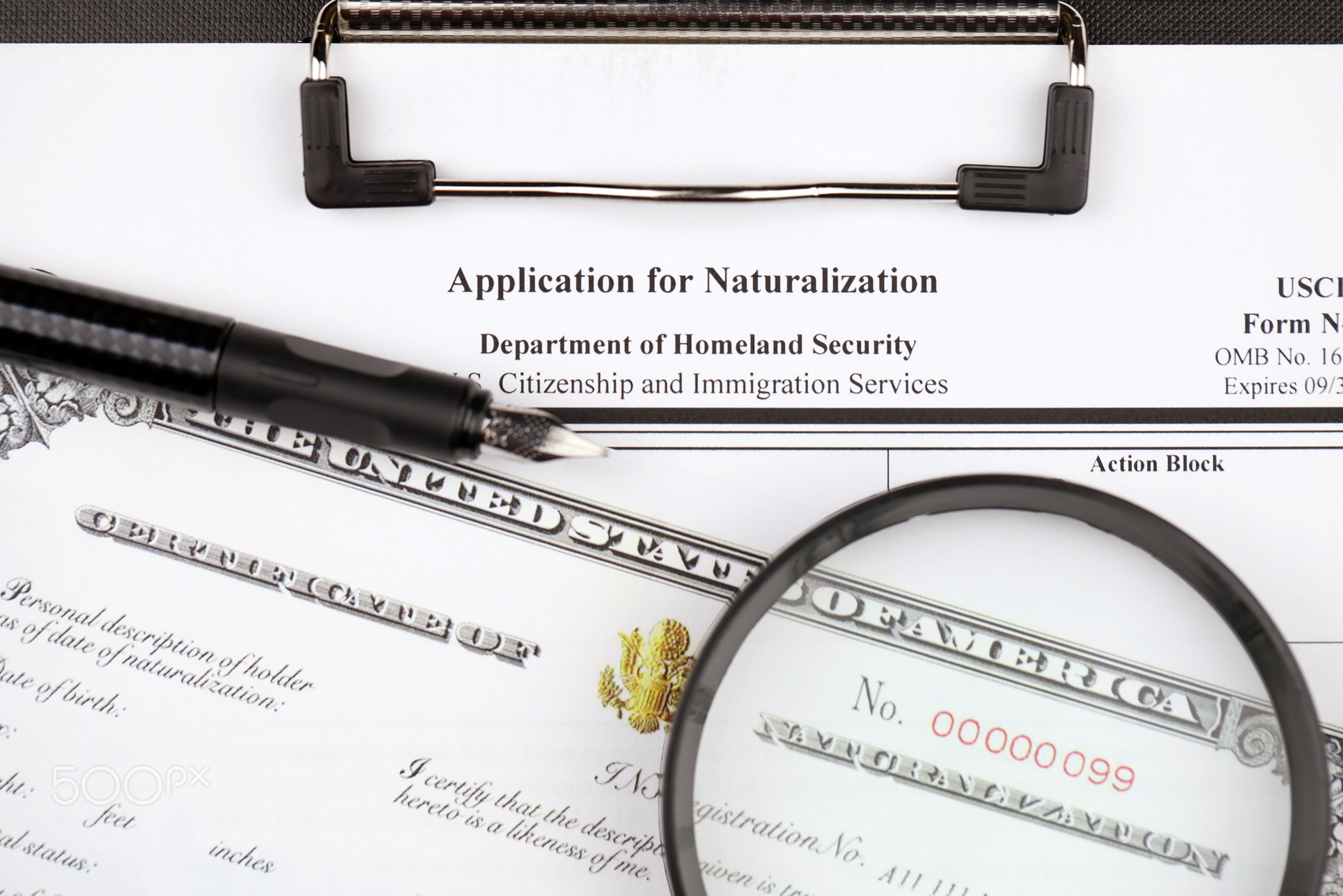 N-400 Application for Naturalization and Certificate of naturalization on A4 tablet lies on office