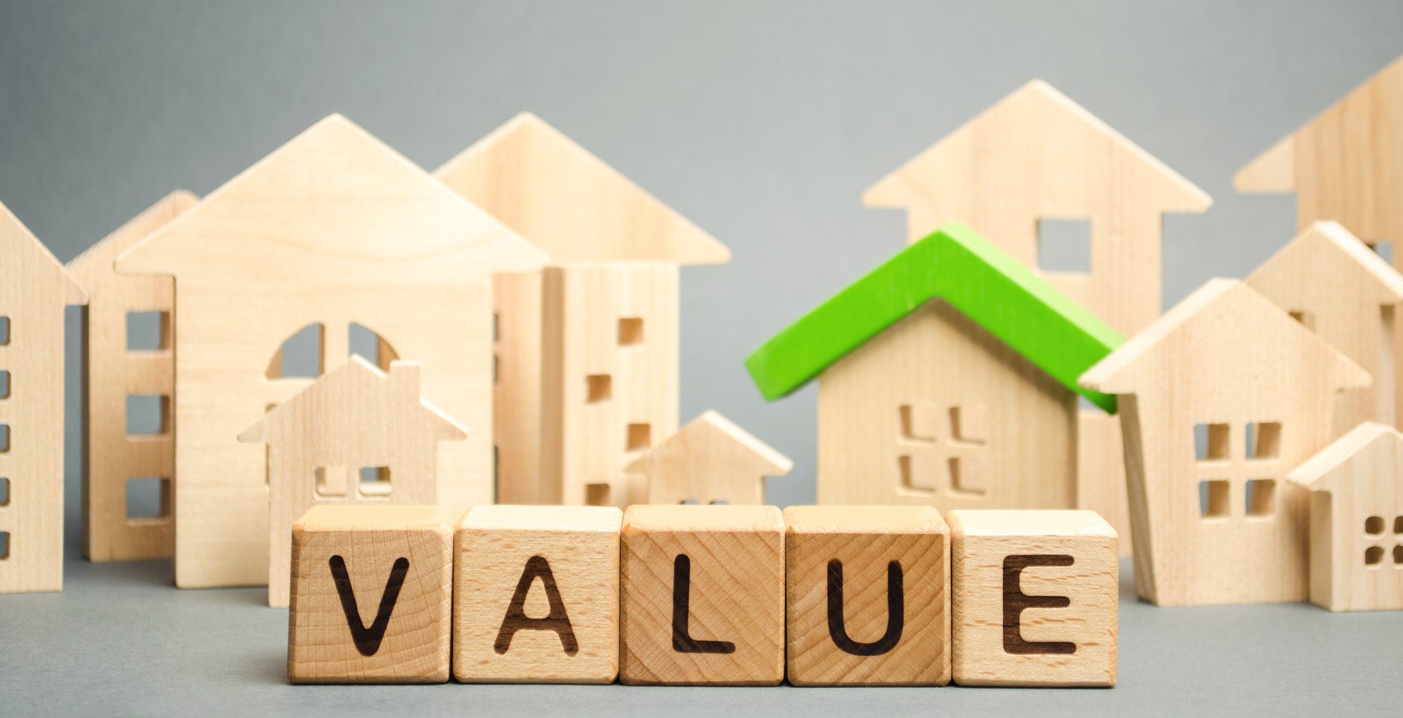 Wooden blocks with the word Value and wooden houses. Property valuation and housing. The best value