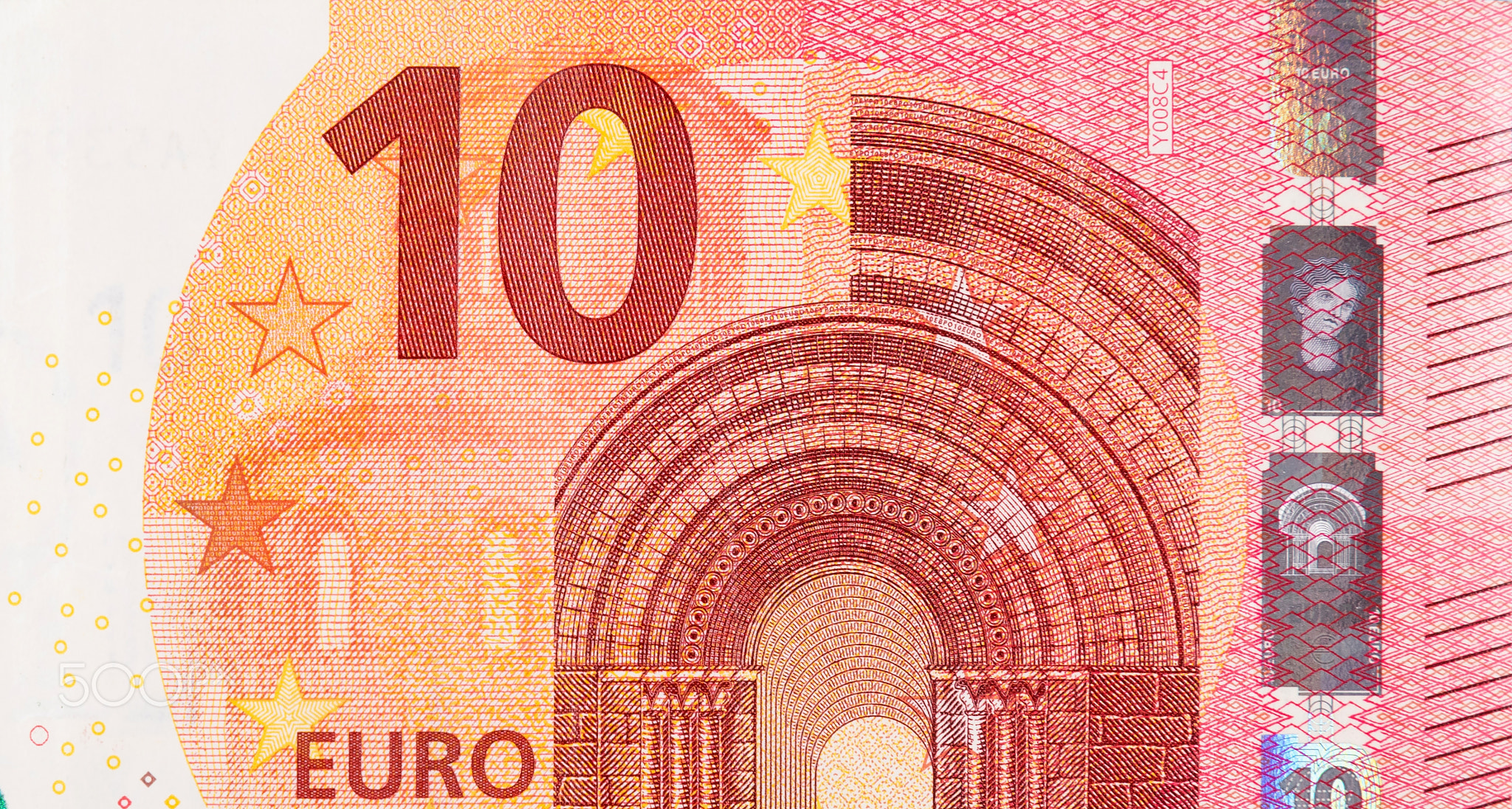 Fragment part of 10 euro banknote close-up with small red details