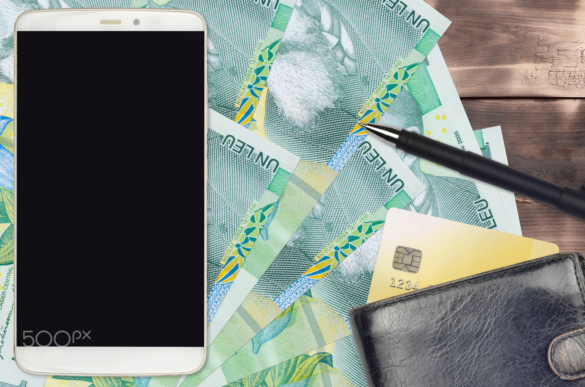 1 Romanian leu bills and smartphone with purse and credit card. E-payments or e-commerce concept