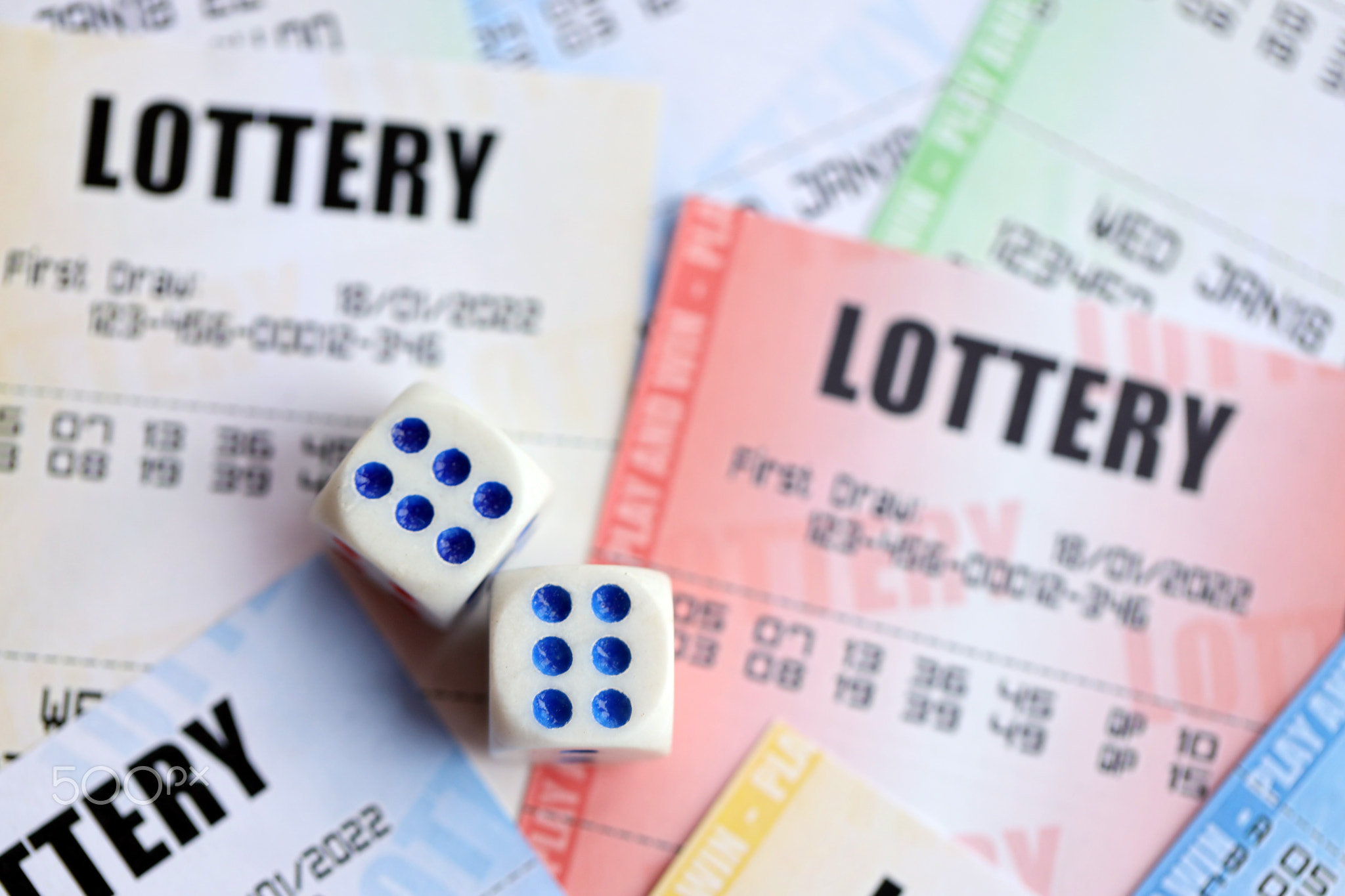 Many lottery tickets and dice on blank bills with numbers for playing lottery
