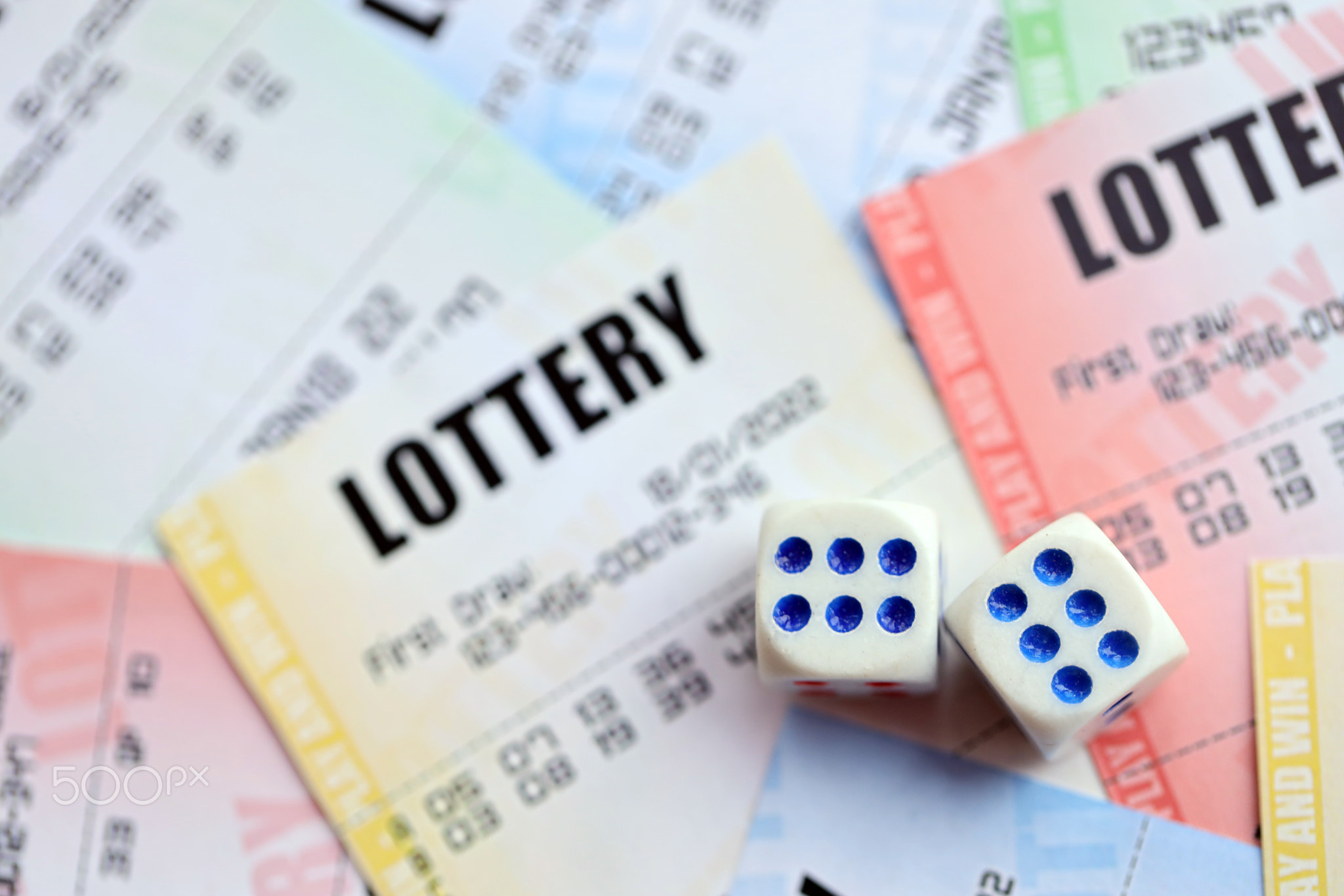 Many lottery tickets and dice on blank bills with numbers for playing lottery