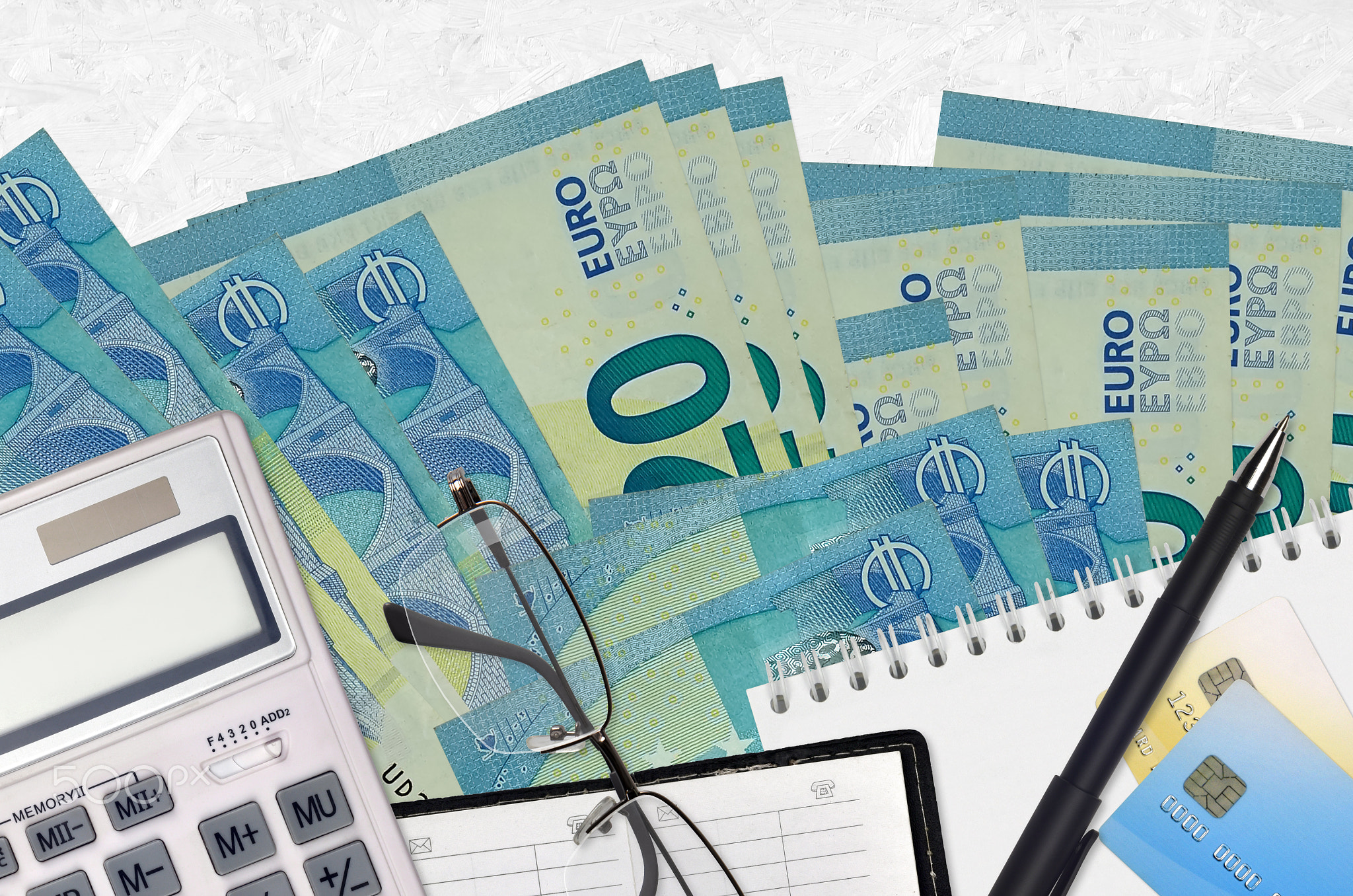 20 euro bills and calculator with glasses and pen. Tax payment concept or investment solutions