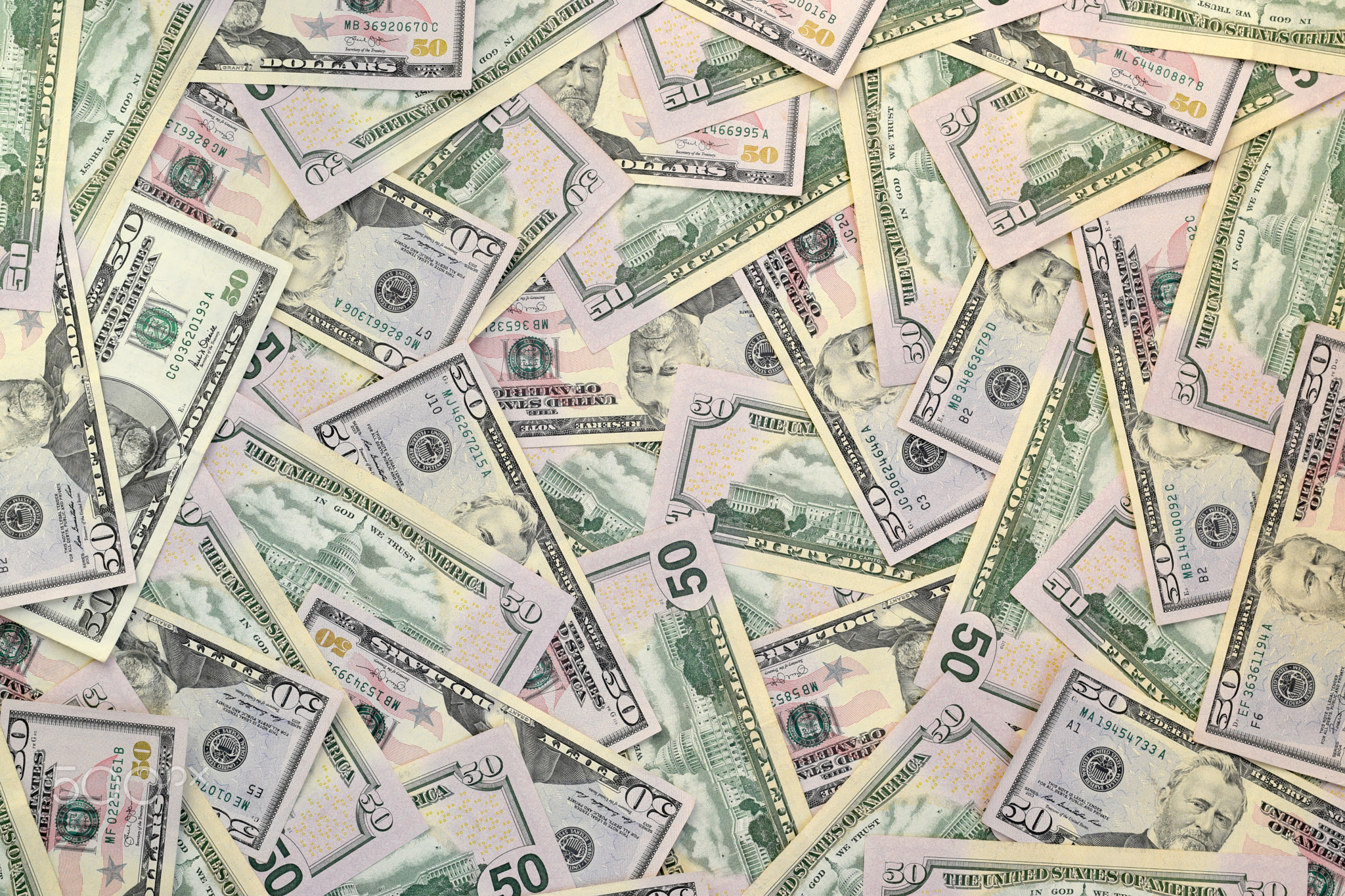Many US fifty dollar bills on flat background surface close up. Flat lay top view. Abstract business