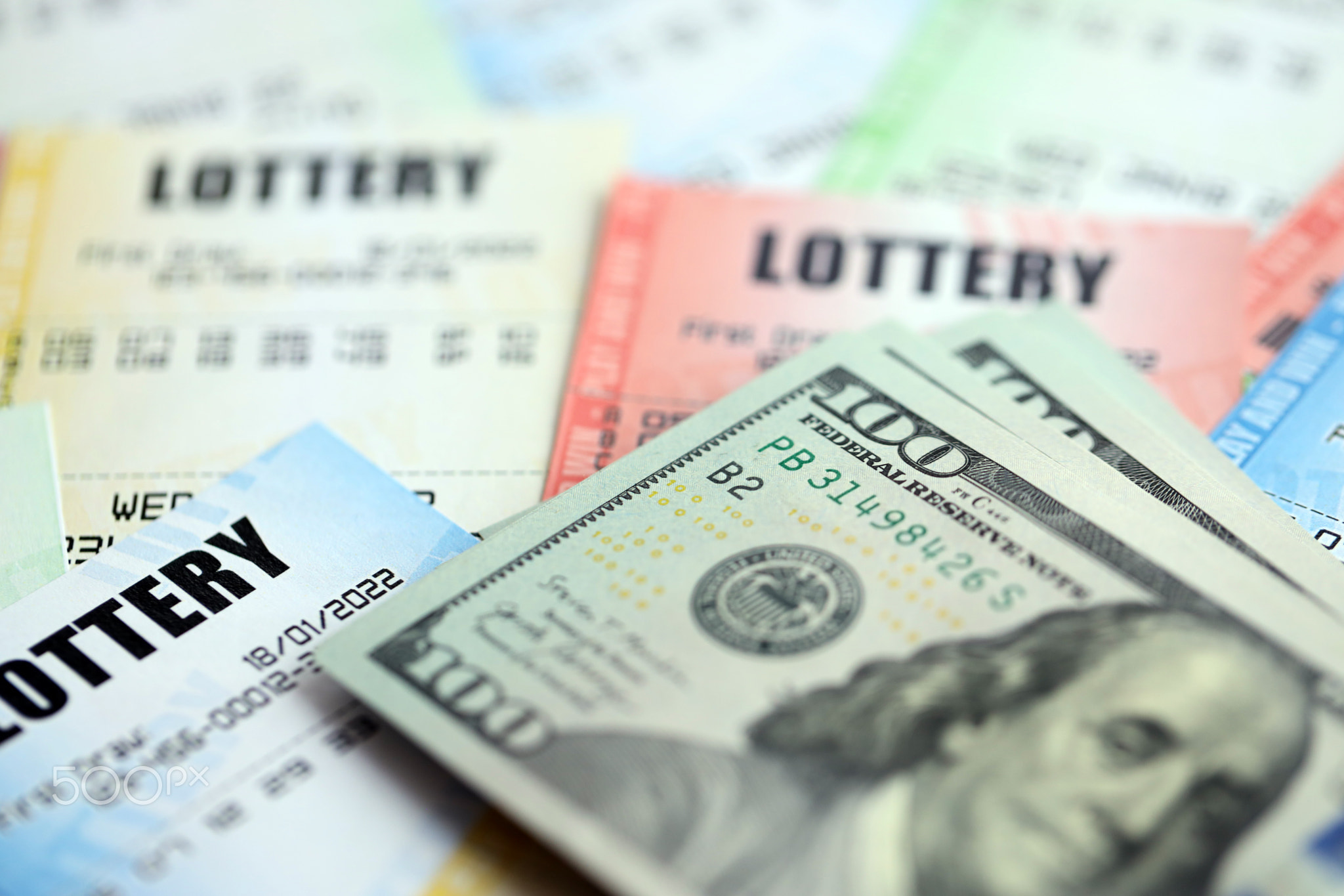 Many lottery tickets and dollar bills on blank bills with numbers for playing lottery