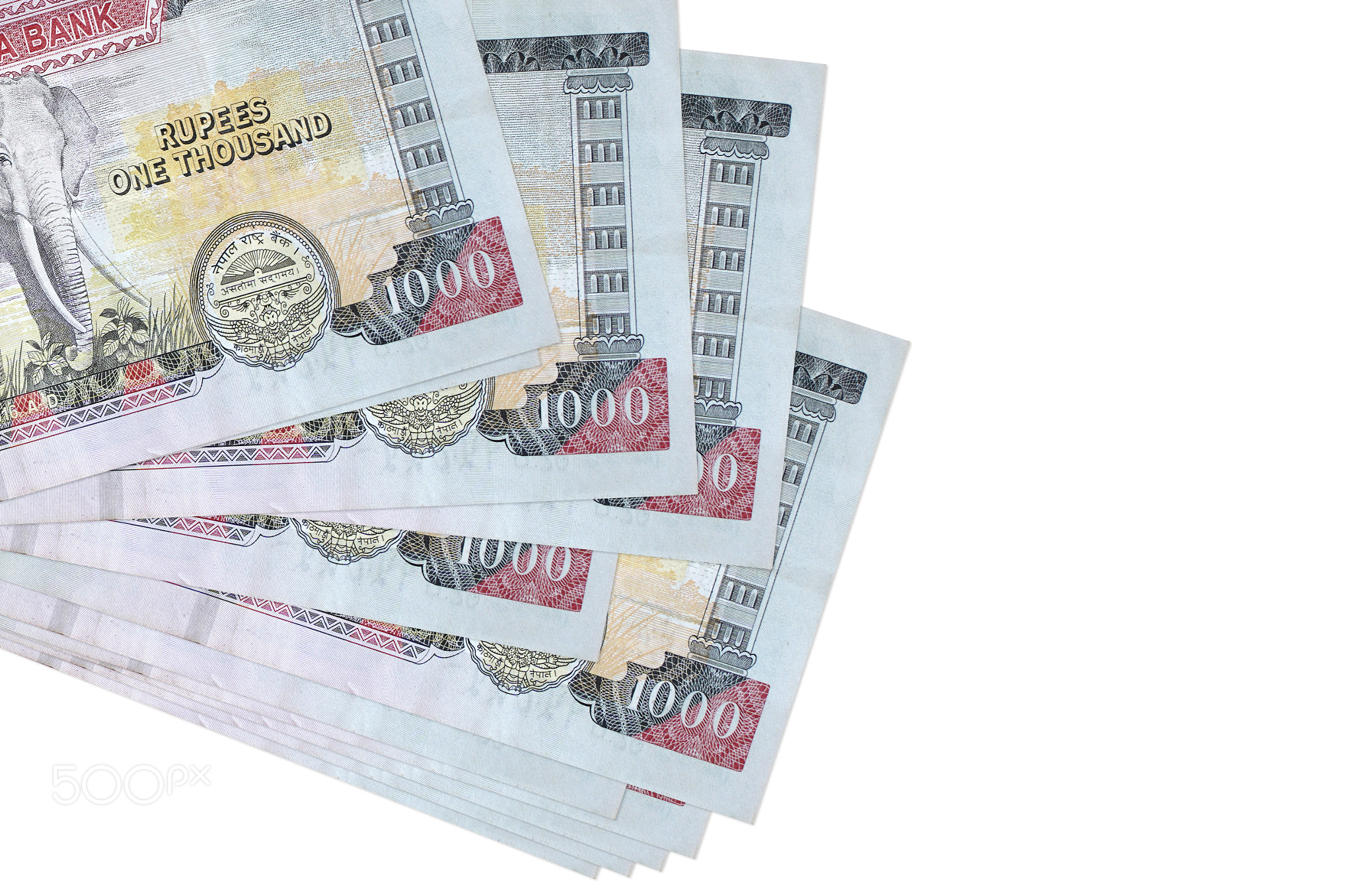 1000 Nepalese rupees bills lies in small bunch or pack isolated on white. Mockup with copy space