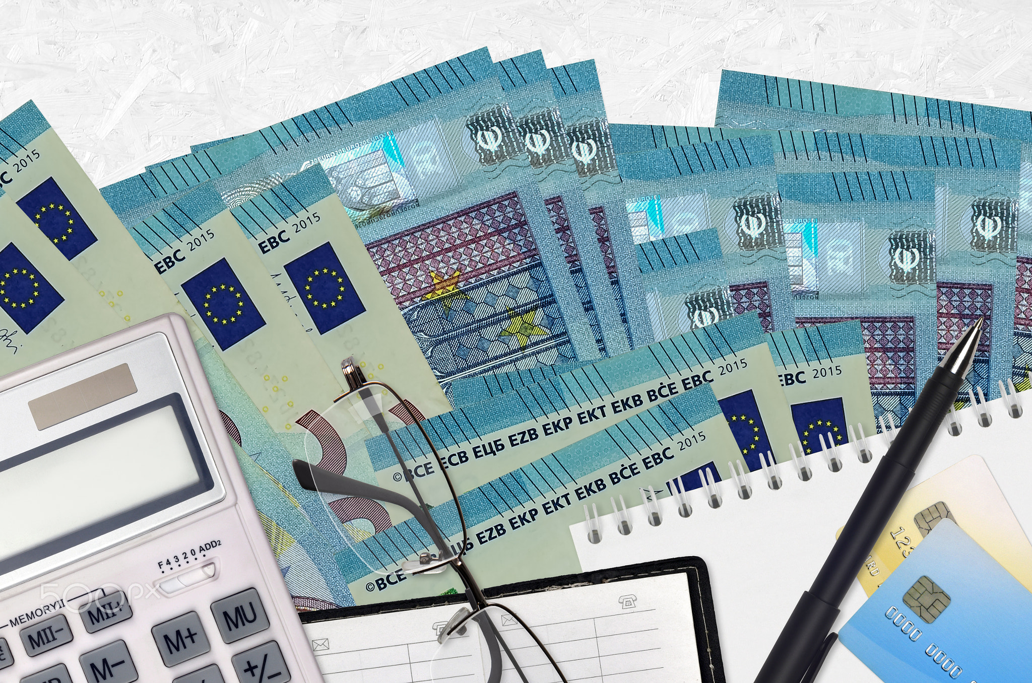 20 euro bills and calculator with glasses and pen. Tax payment concept or investment solutions