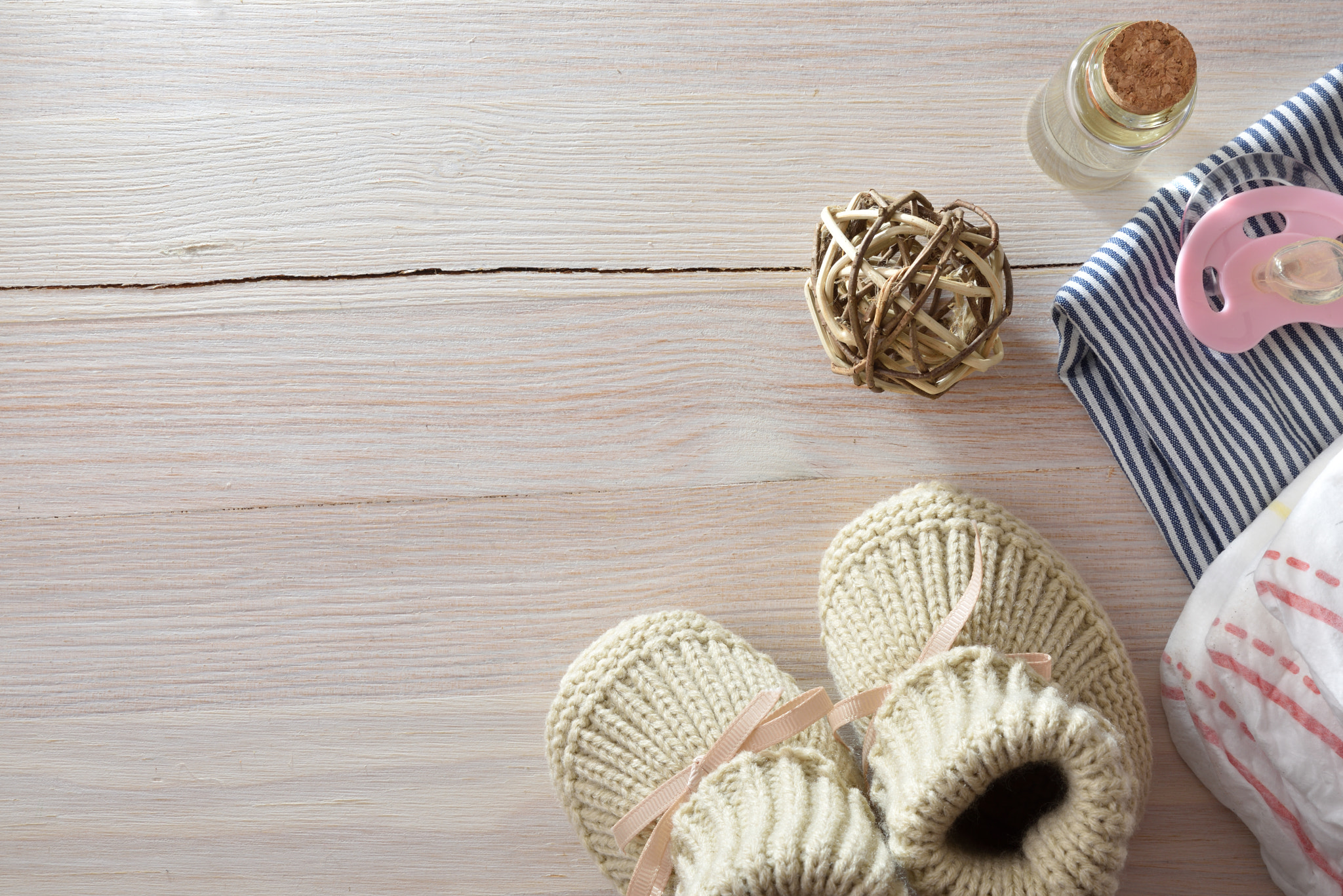 Background with baby accessories on wooden table.