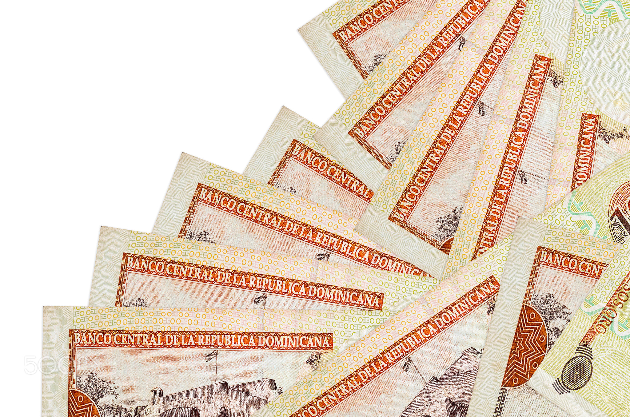 100 Dominican peso bills lies in different order isolated on white. Local banking or money making
