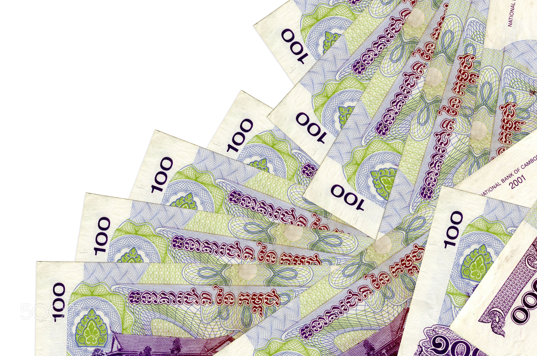 100 Cambodian riels bills lies in different order isolated on white. Local banking or money making