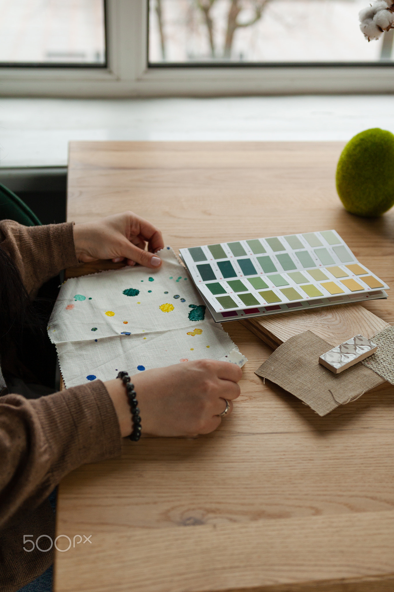 Hands Holding Color Swatches for Design