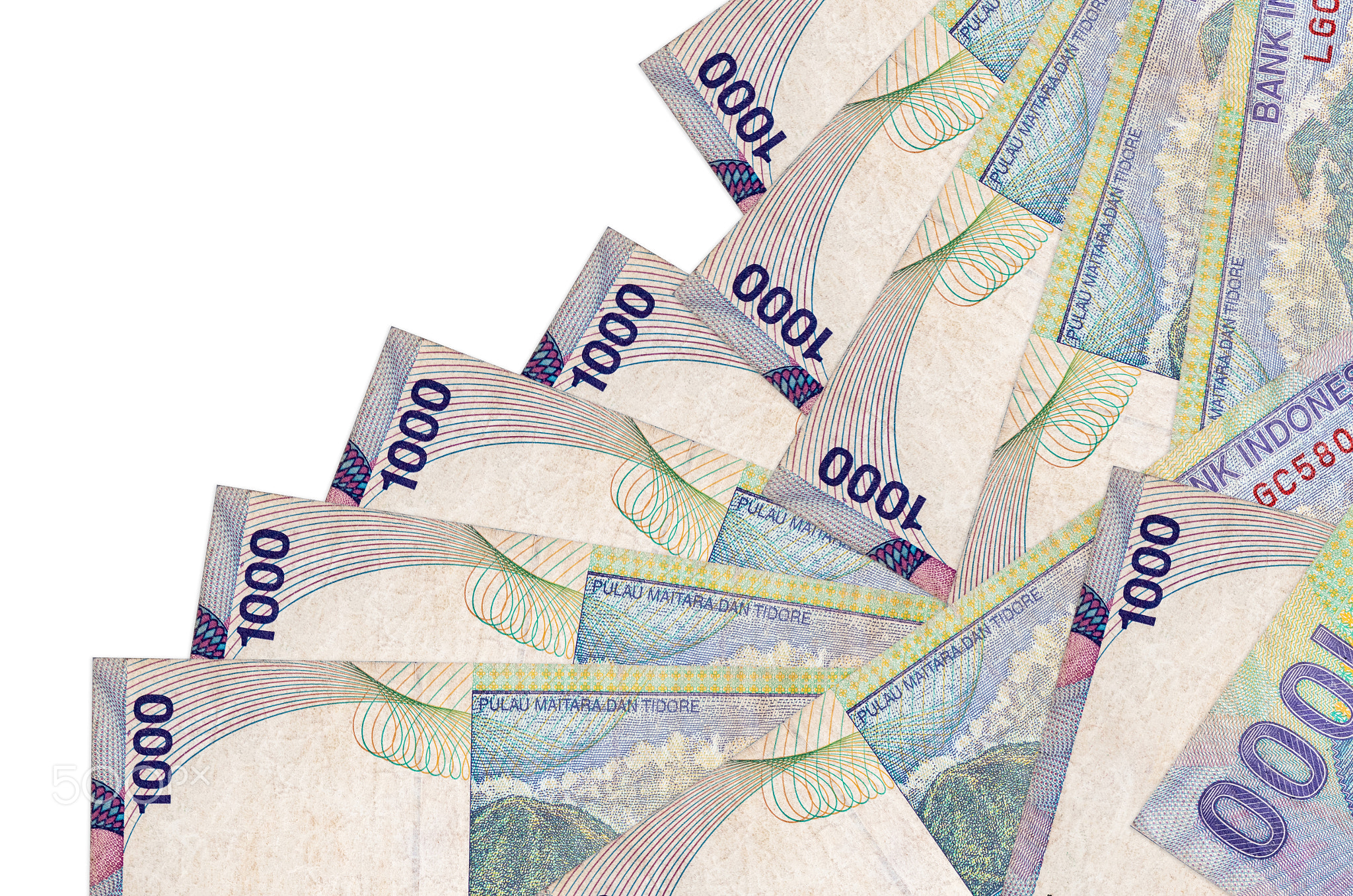 1000 Indonesian rupiah bills lies in different order isolated on white. Local banking or money