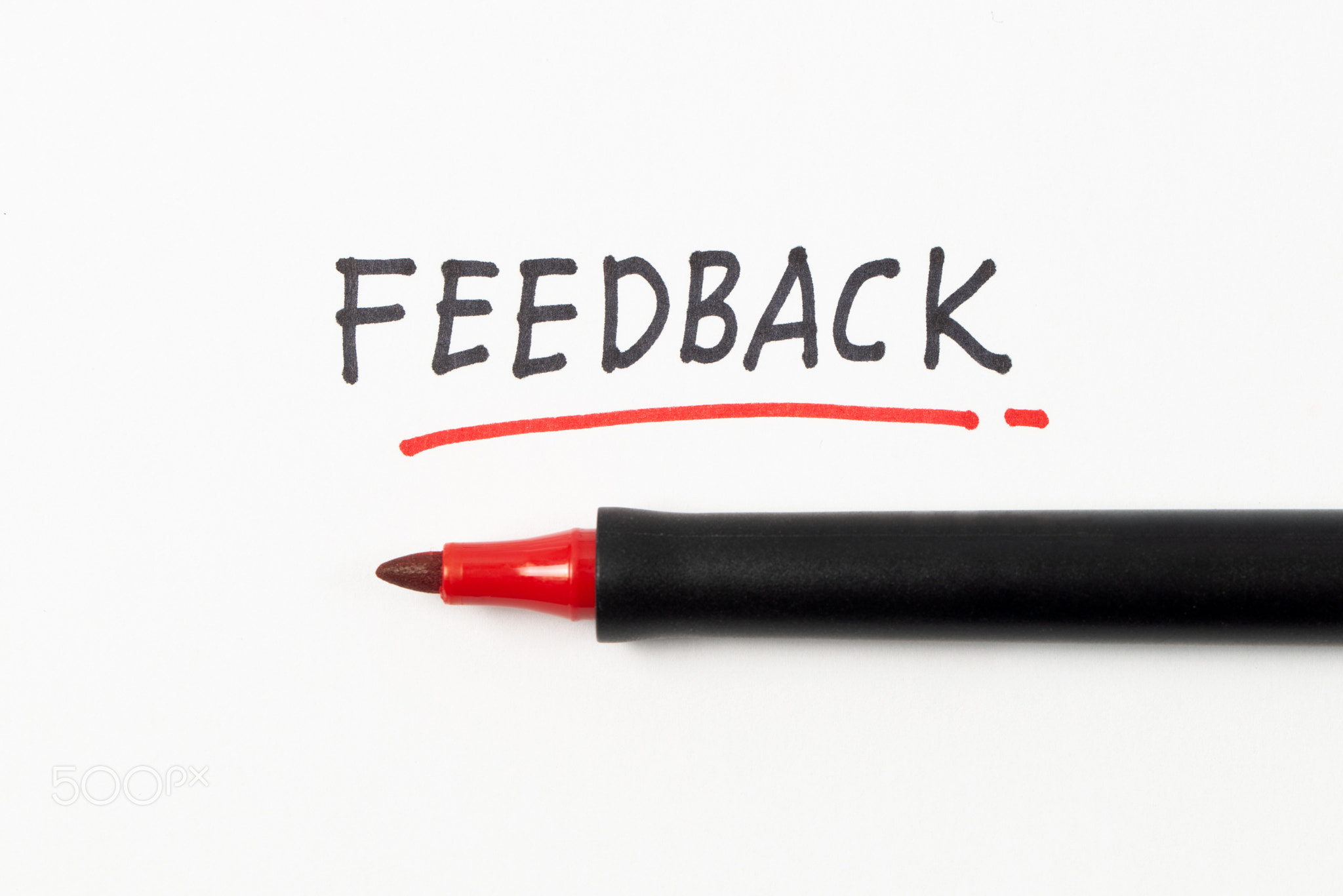 Hand writing Feedback with black and red marker on white paper