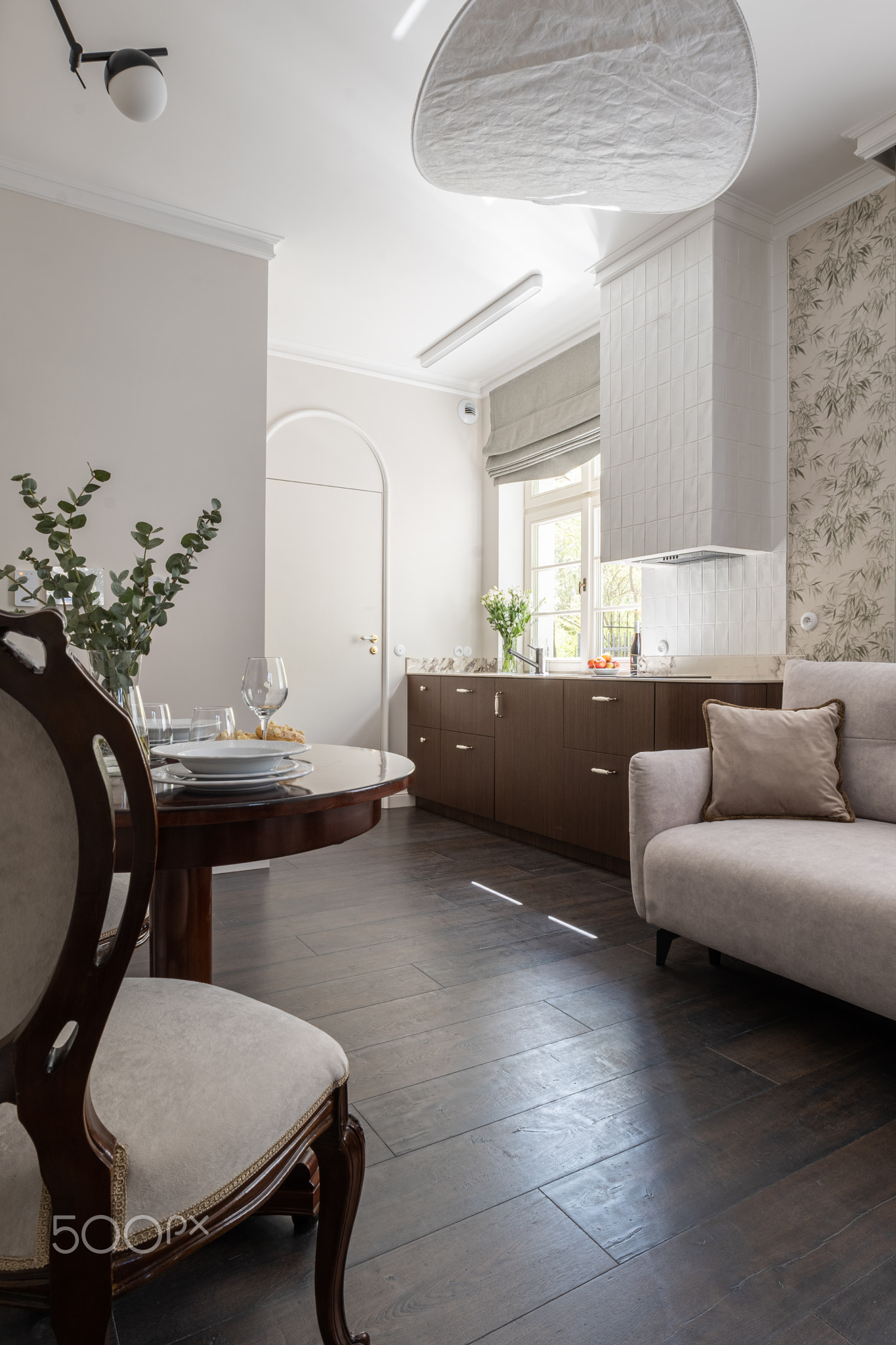 A living room with furniture like a couch, table, and chairs