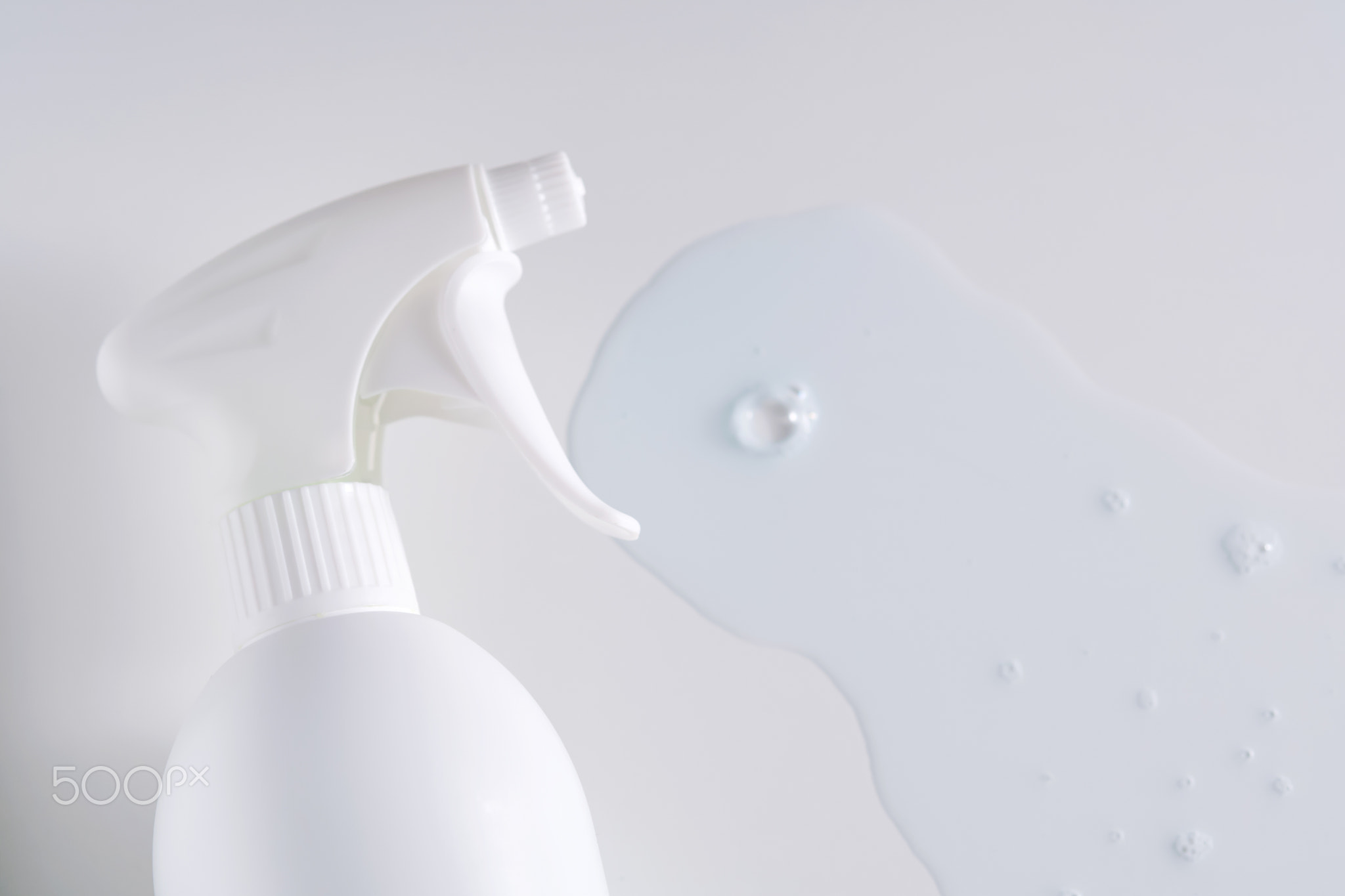 Cleaning product with a sprayer on a white background with with a sample.