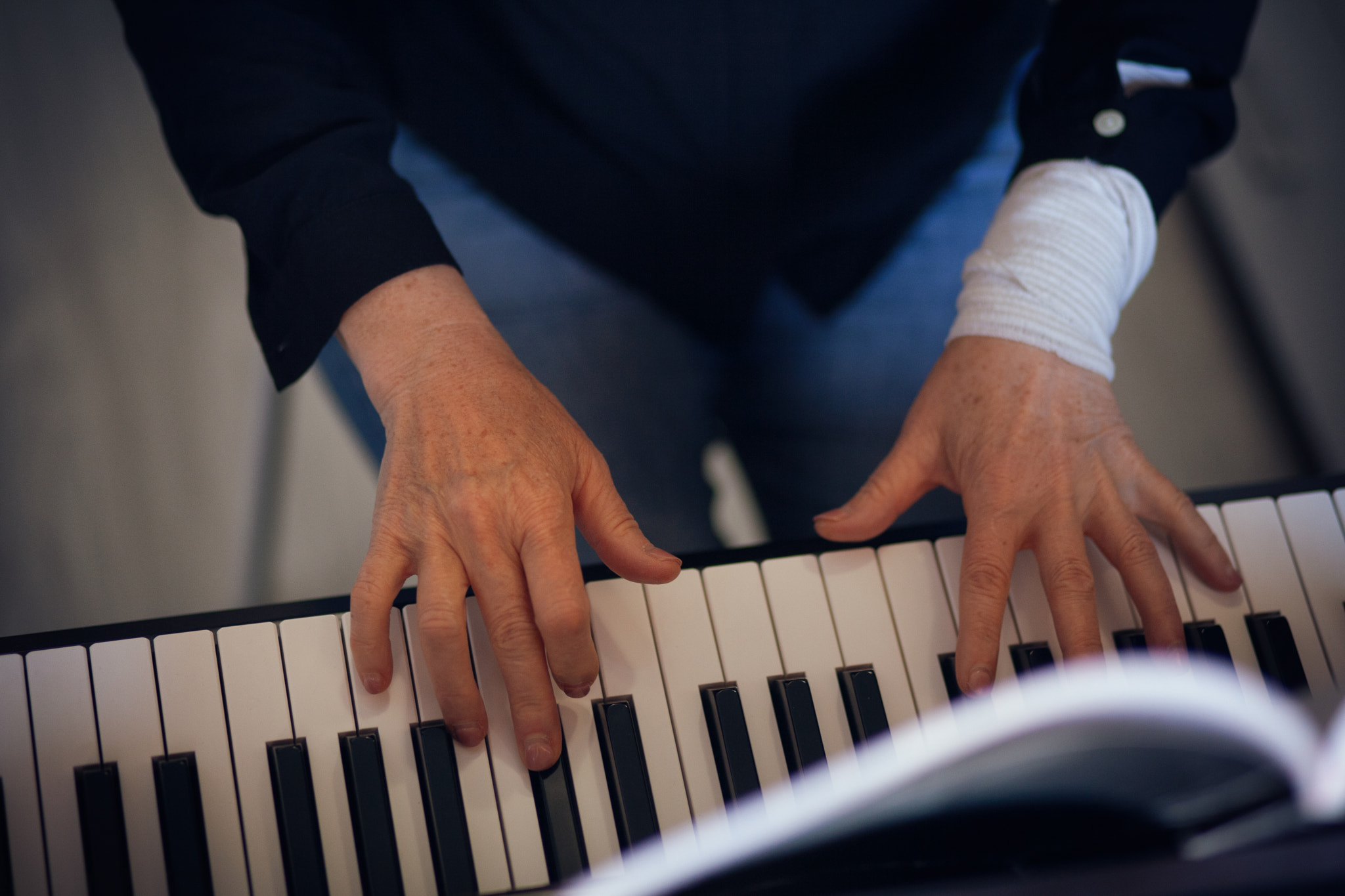 A woman plays the piano. Close-up shot of woman's hands