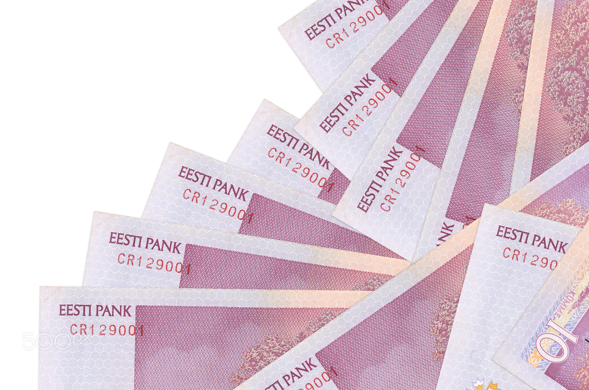 10 Estonian kroon bills lies in different order isolated on white. Local banking or money making