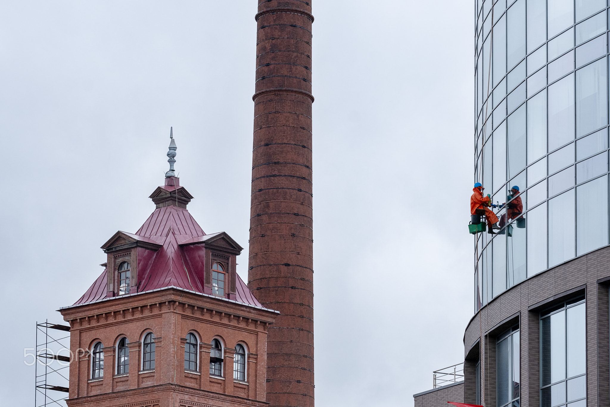 St. Petersburg, Russia - May 10, 2024. An industrial climber washes the windows.