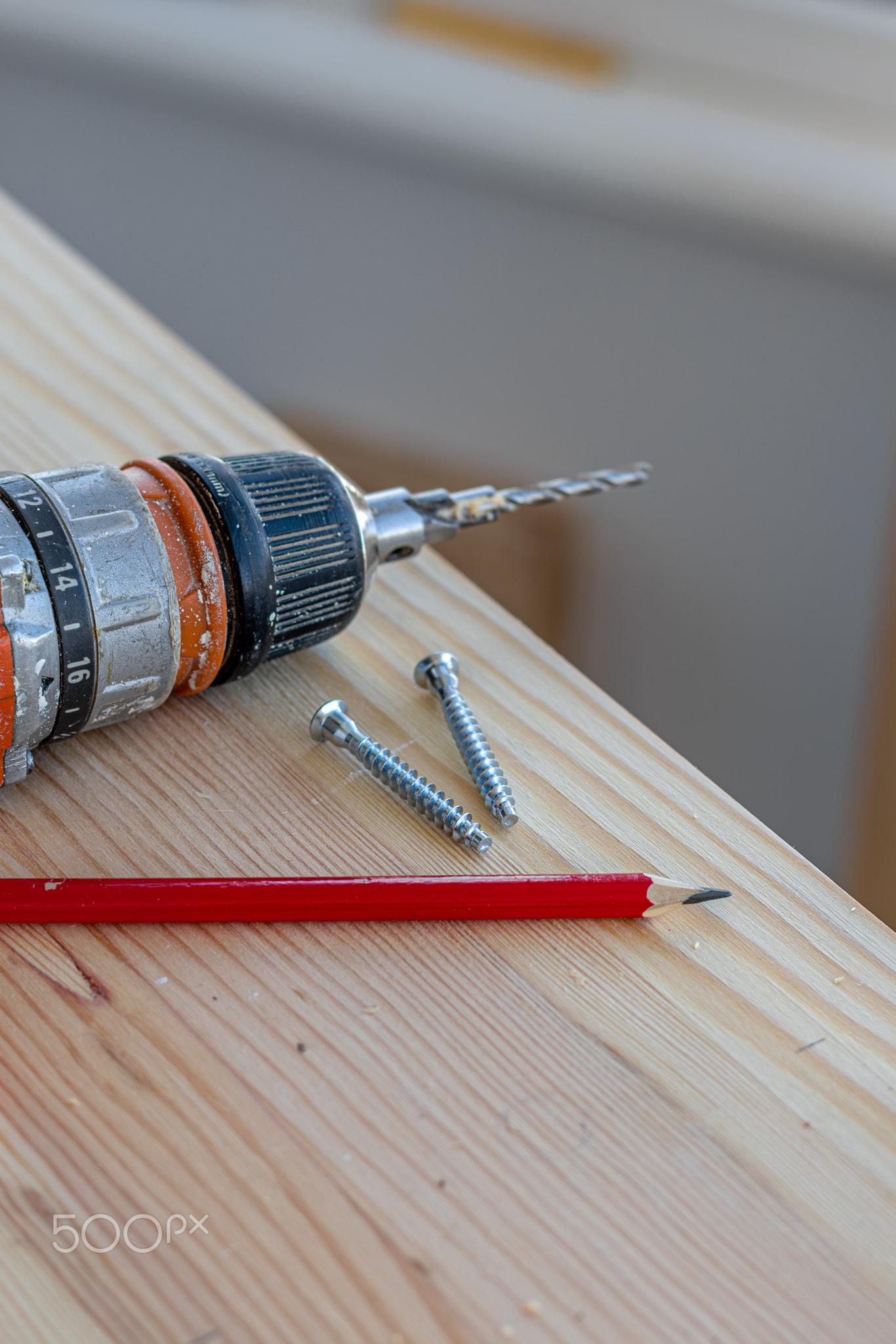 screwdriver, two confirmations and a pencil on the board