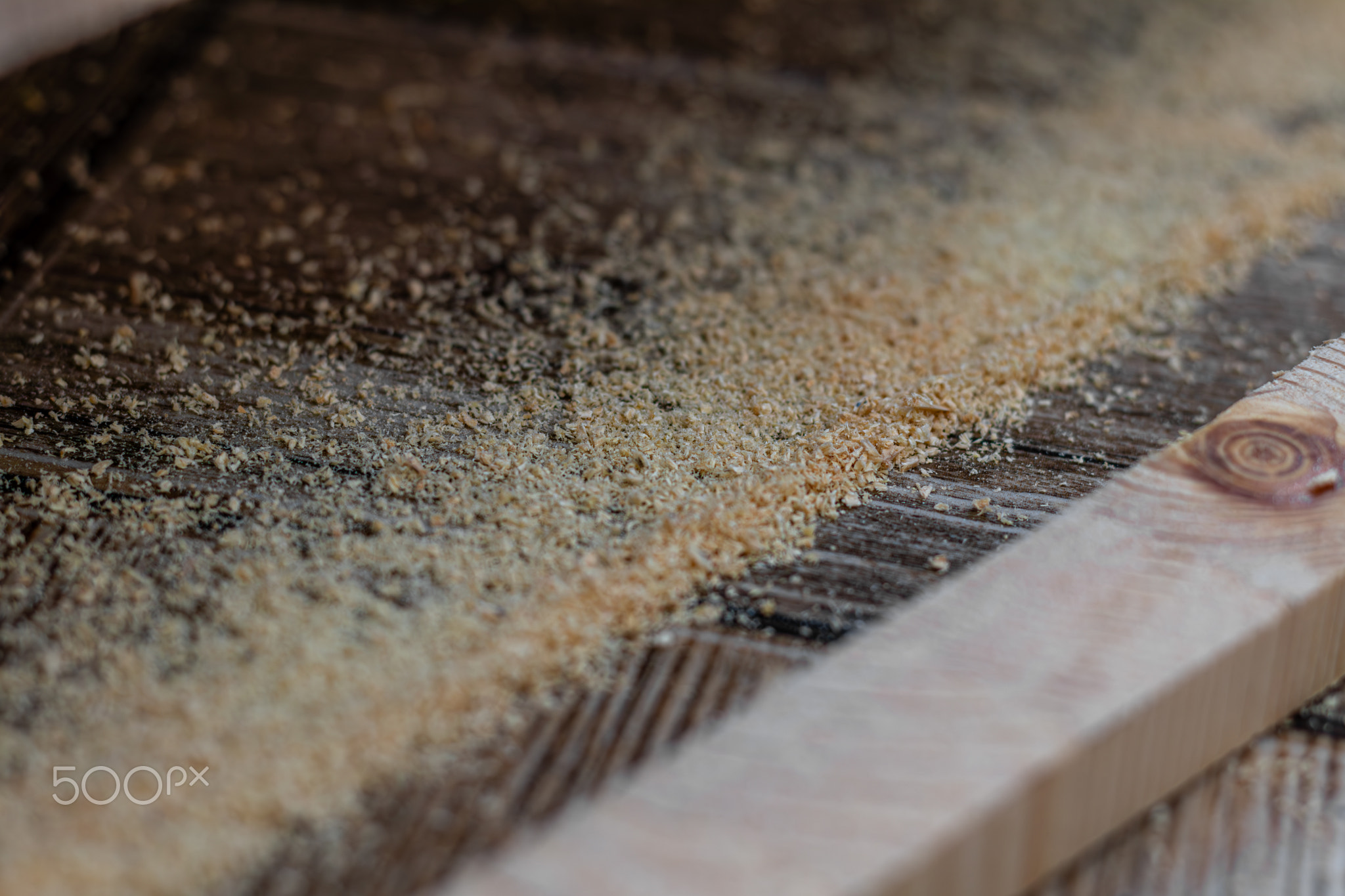 a cut off piece of board with an electric jigsaw on the floor