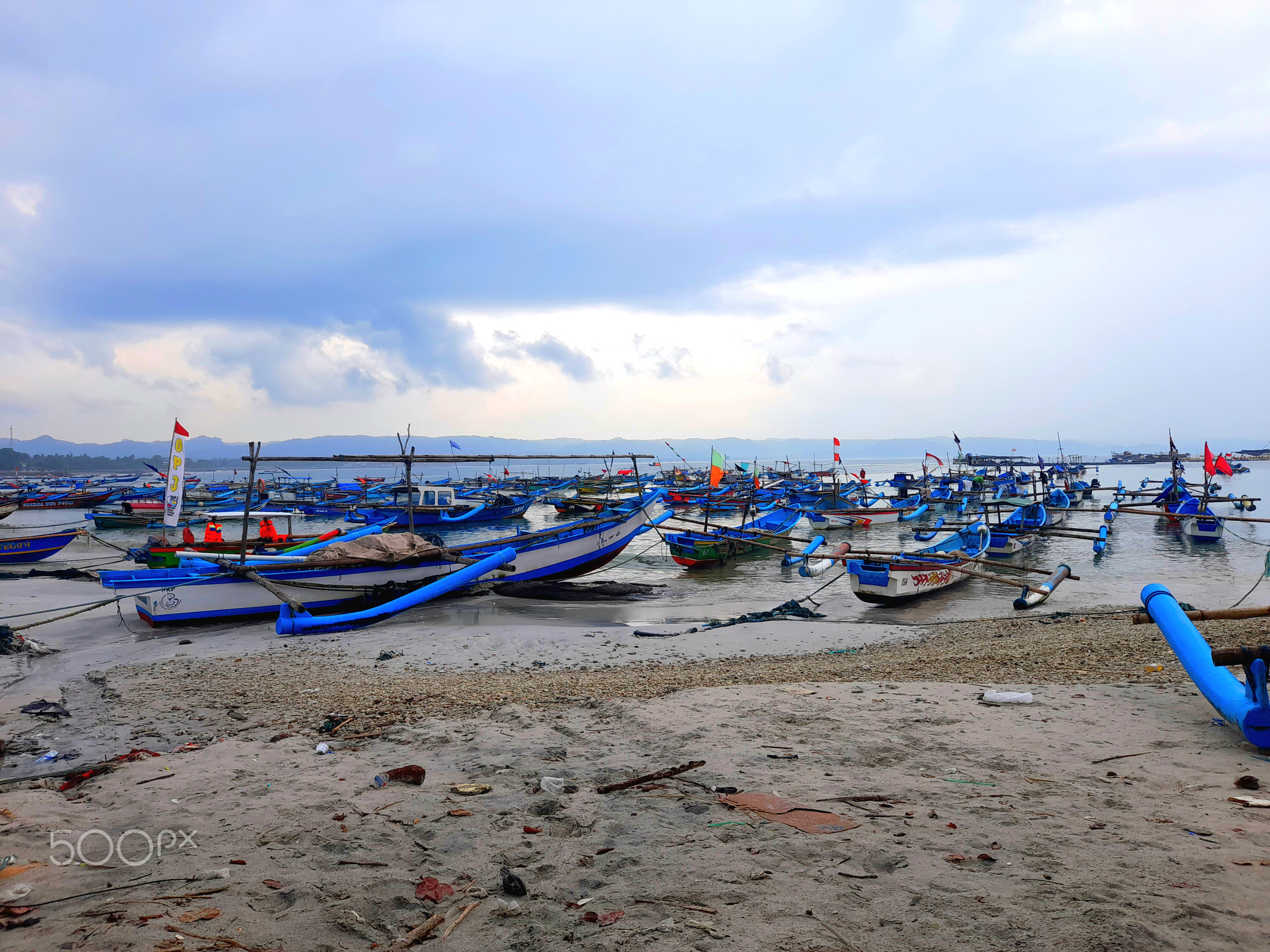 several fishing boats going out to sea