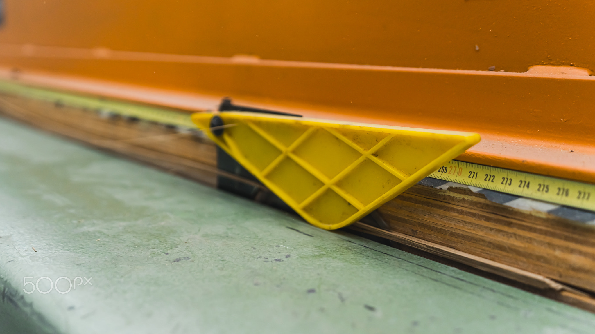 measuring tape on the wood thing to measure the length, workshop
