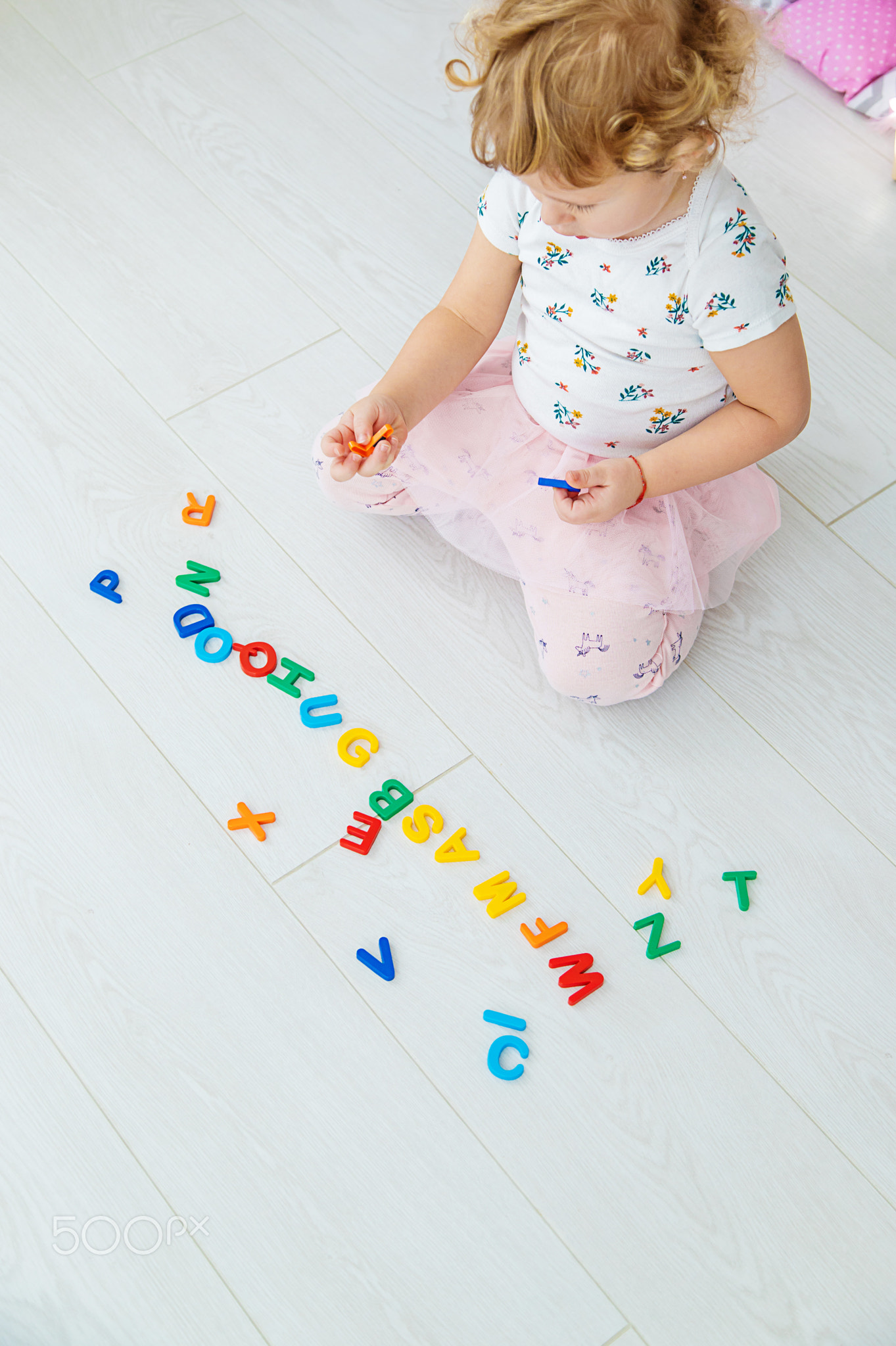 The child plays learns numbers and letters. Selective focus.