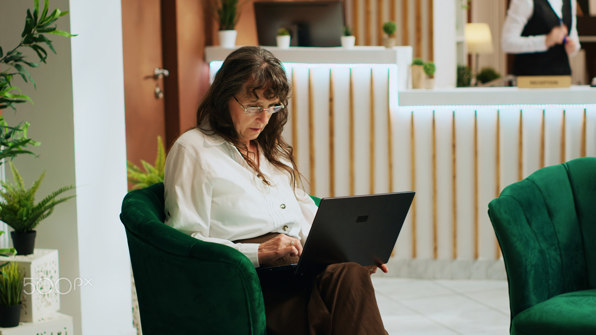 Tourist using laptop in lounge area