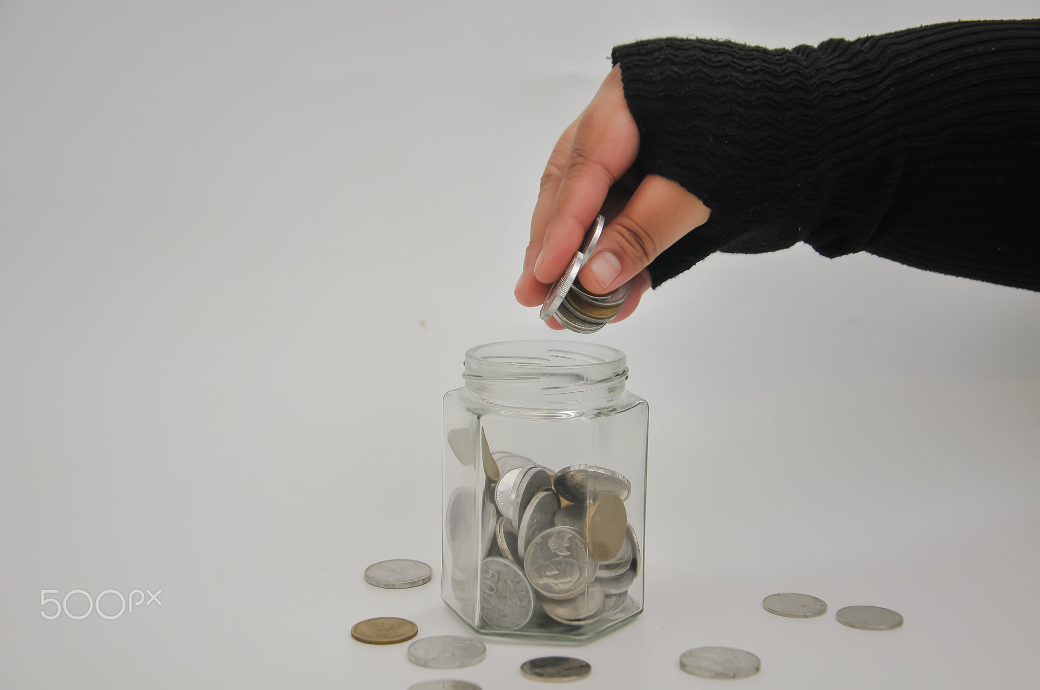 hand holding coins for saving, no people, investment concept\t