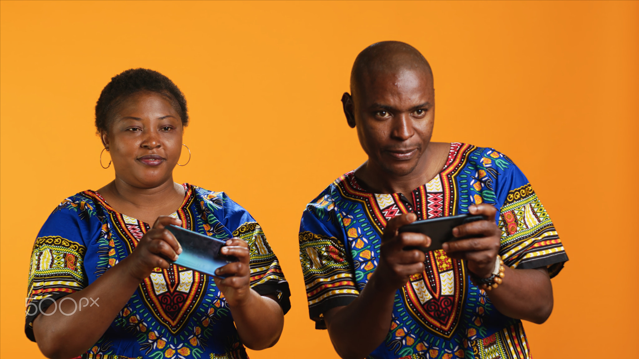 African american couple playing mobile videogames on camera