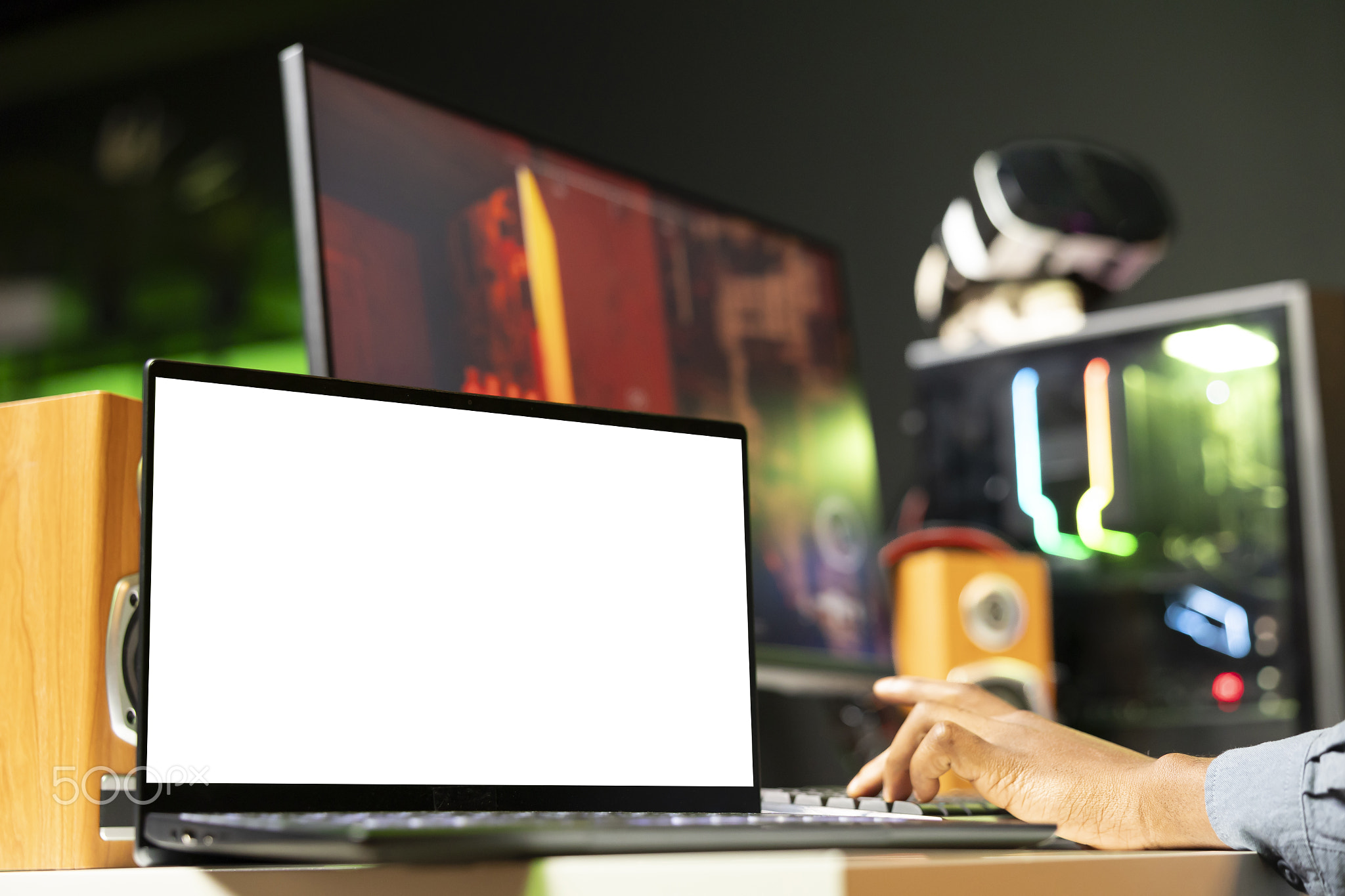 Mockup laptop display next to man playing FPS singleplayer videogame
