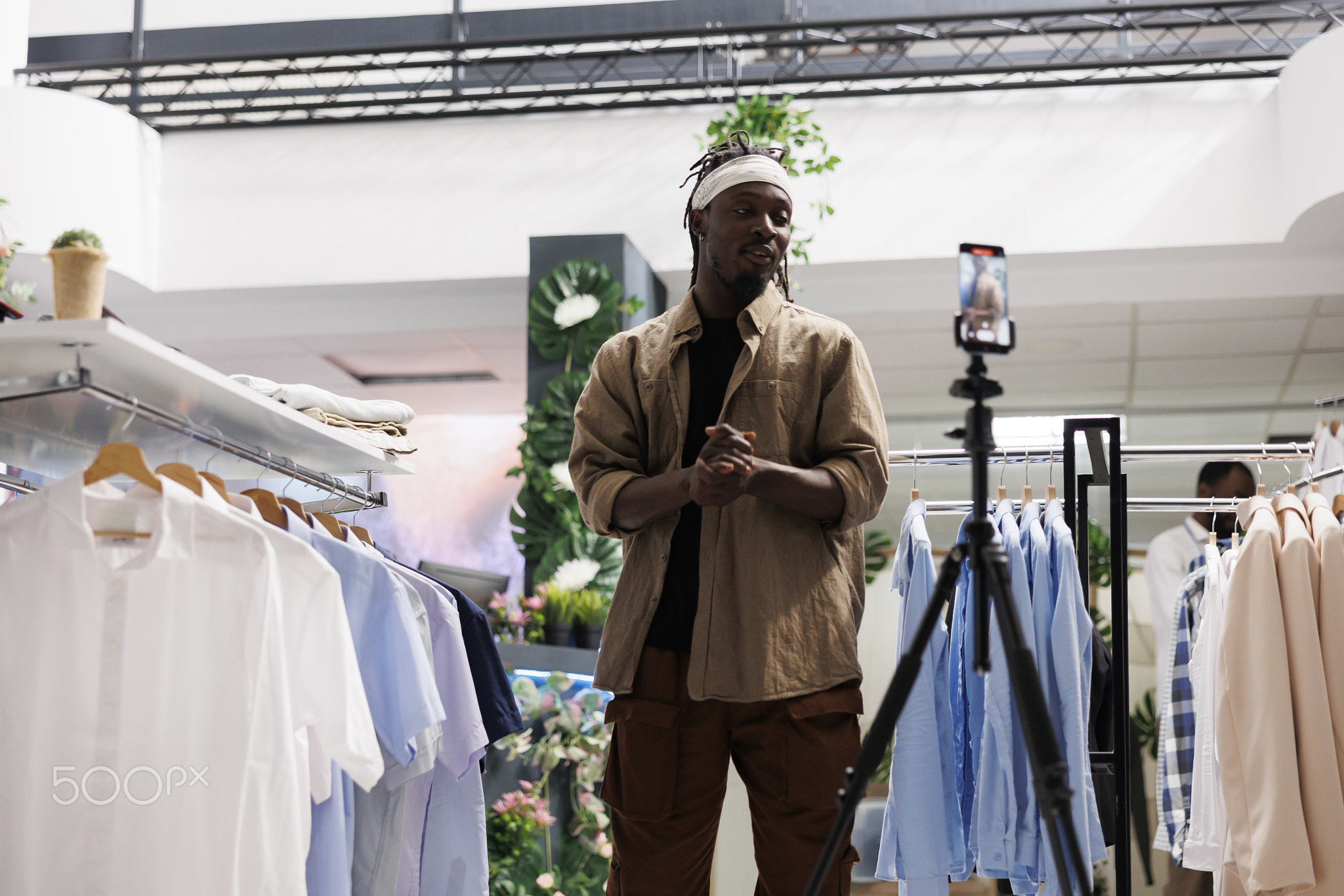 Blogger recording promotional video in clothing store