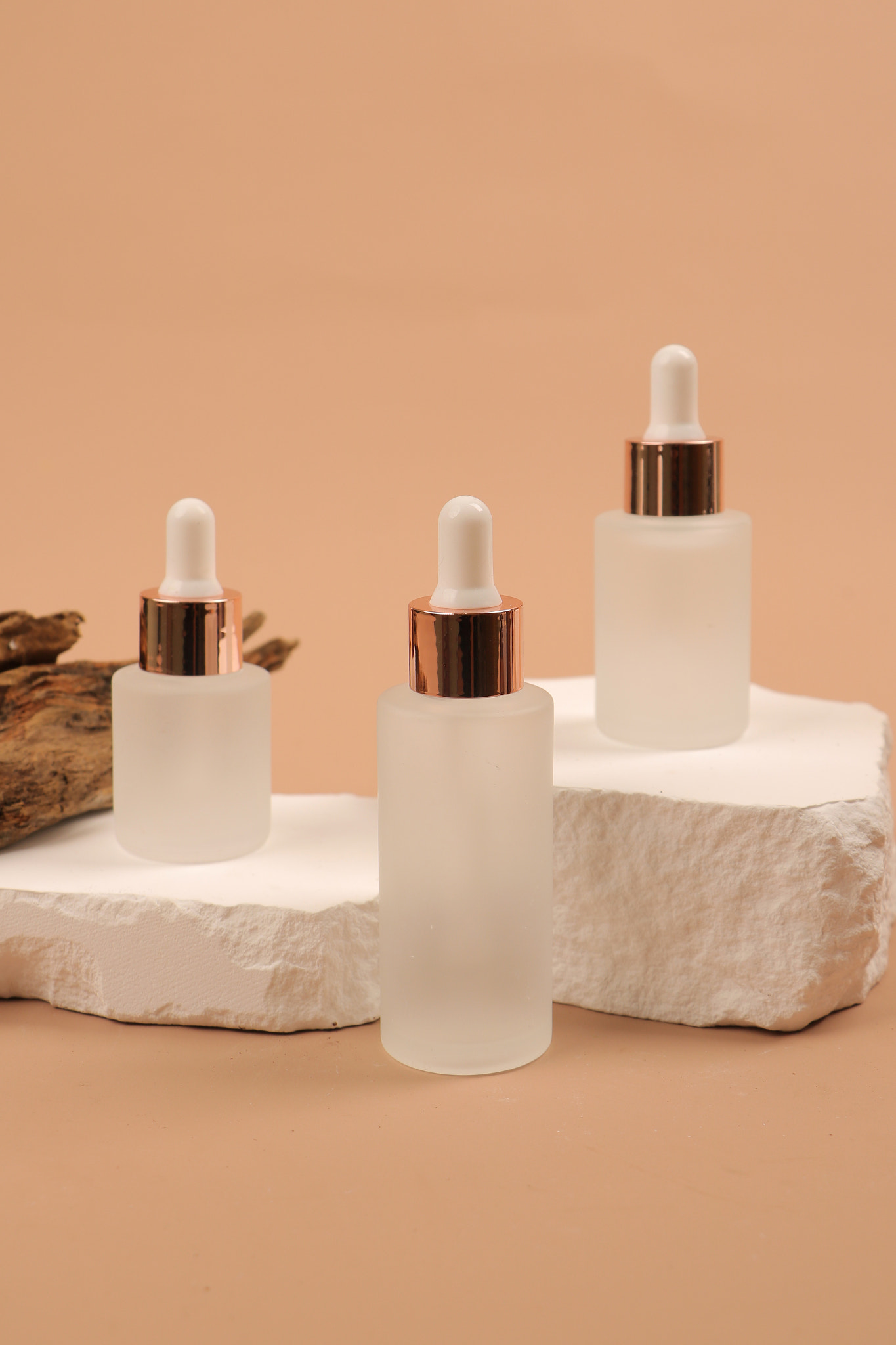 Minimalist Skincare Serum Bottles on Stone Pedestal