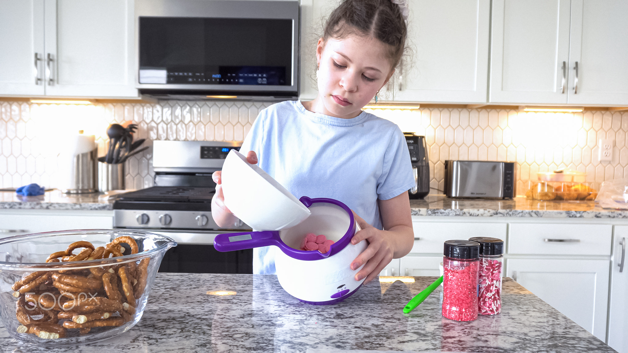 Young Chef Prepares Chocolate-Covered Treats in Sunny Kitchen