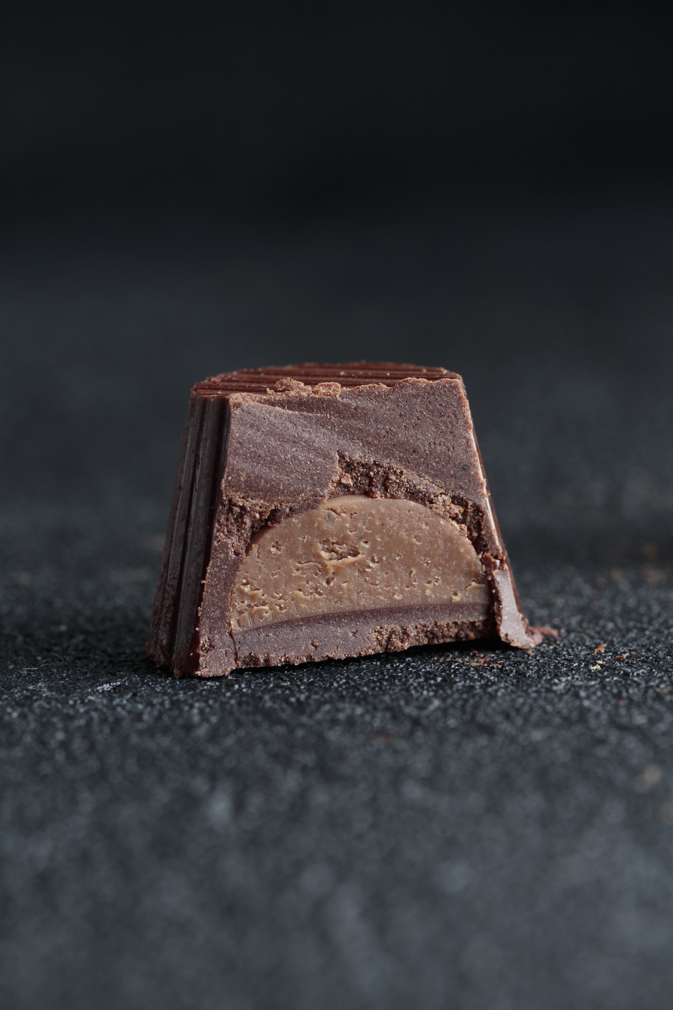 Delicious gourmet homemade dark chocolate candy from confectionery on black background