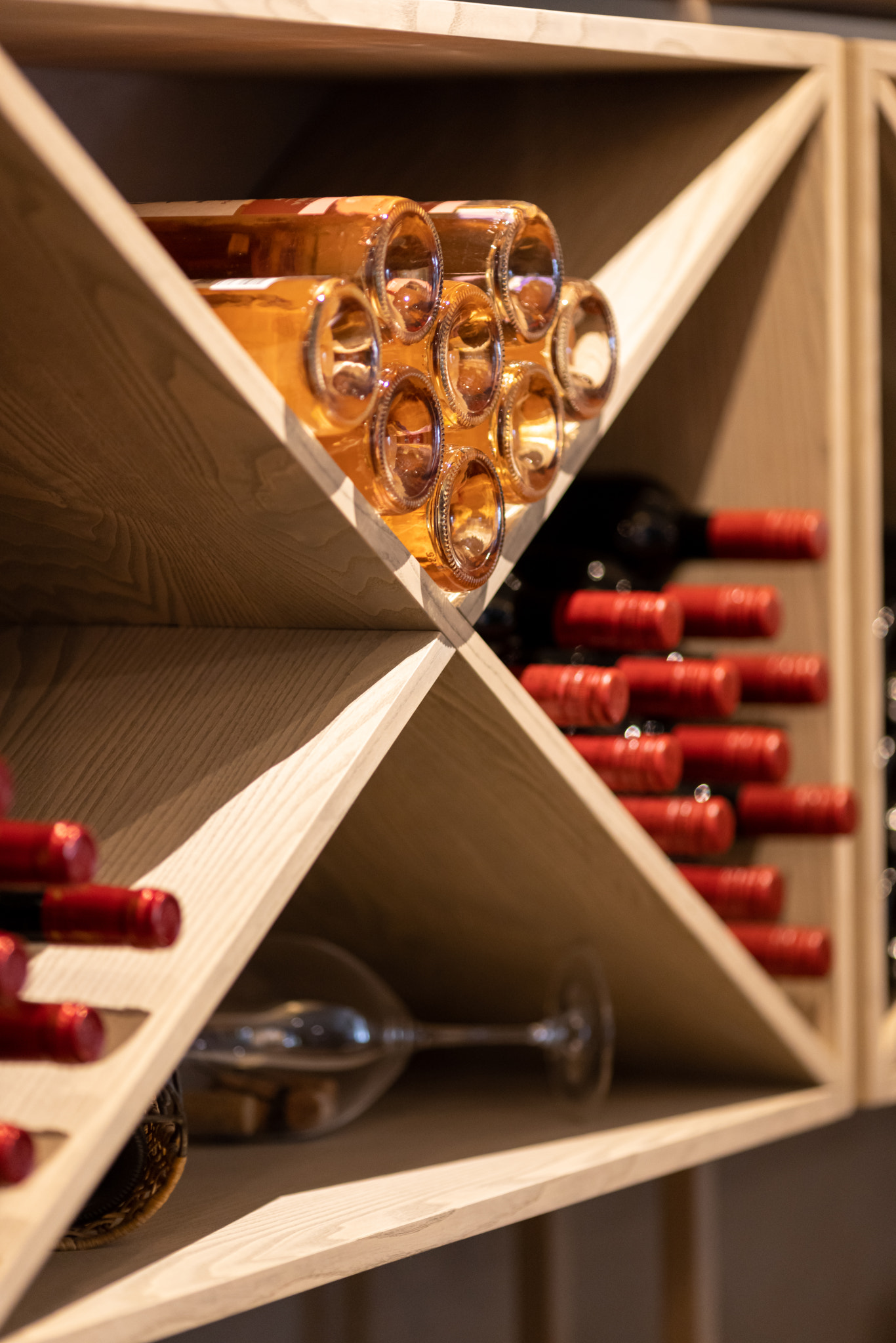 Light wood wine rack with bottles, white, pink, red wine