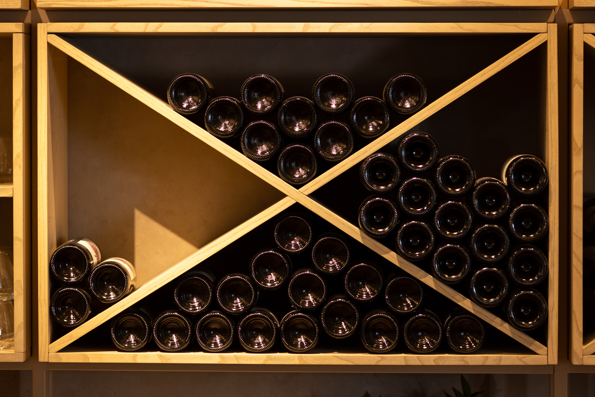 Light wood wine rack with bottles, white, pink, red wine