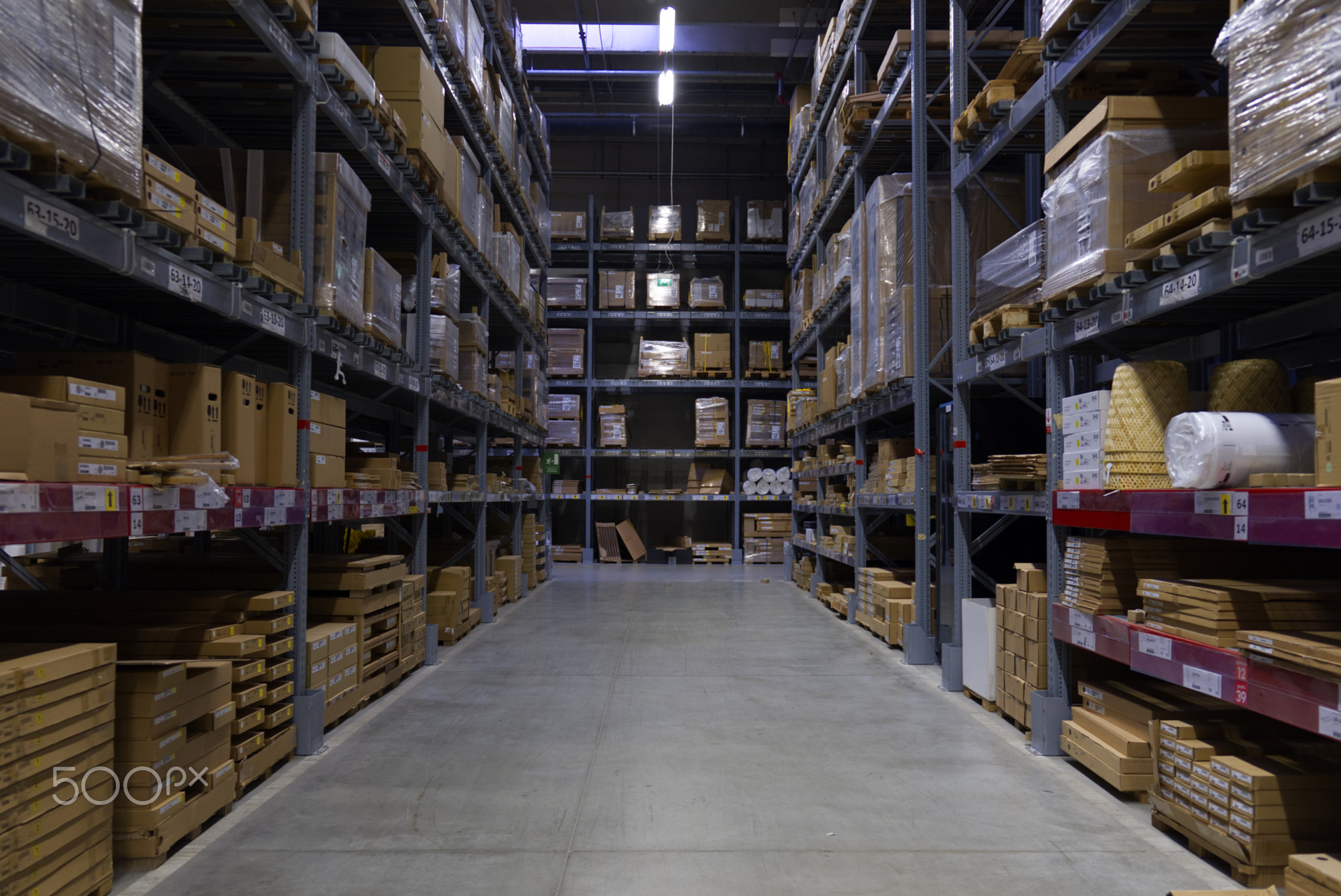 Spacious Warehouse Interior with Rows of Shelves Stocked with Boxes