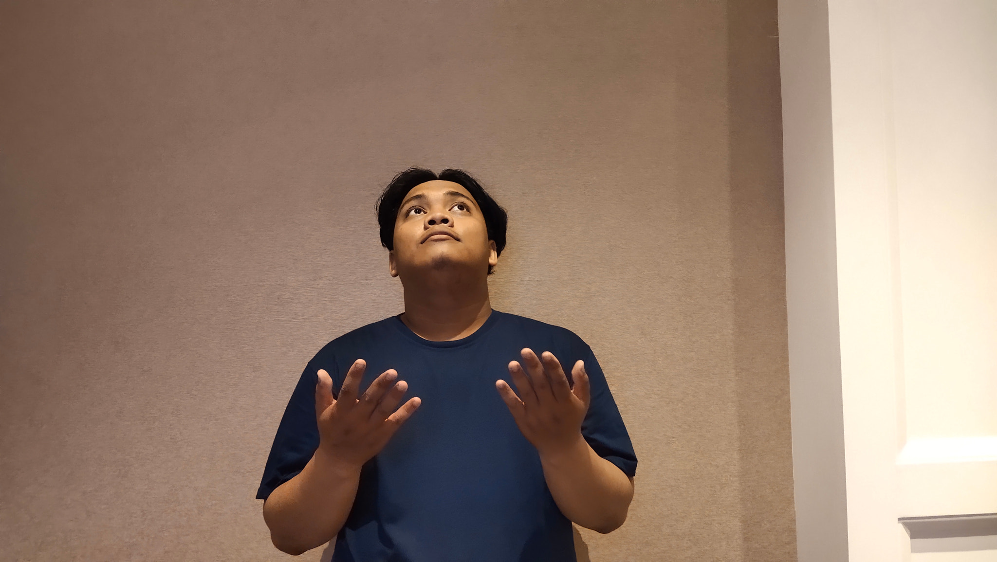 Young man standing against wall
